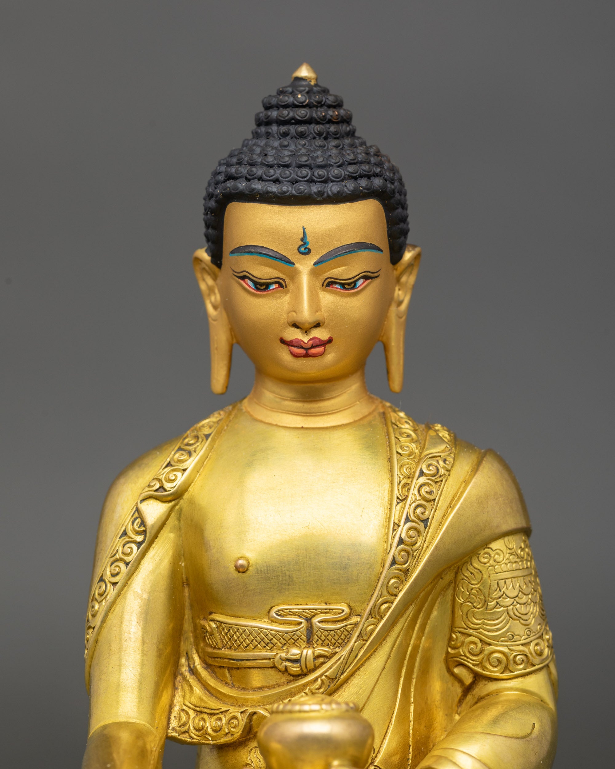 Close-up of Shakyamuni Buddha Statue highlighting gold fire-gilded copper details