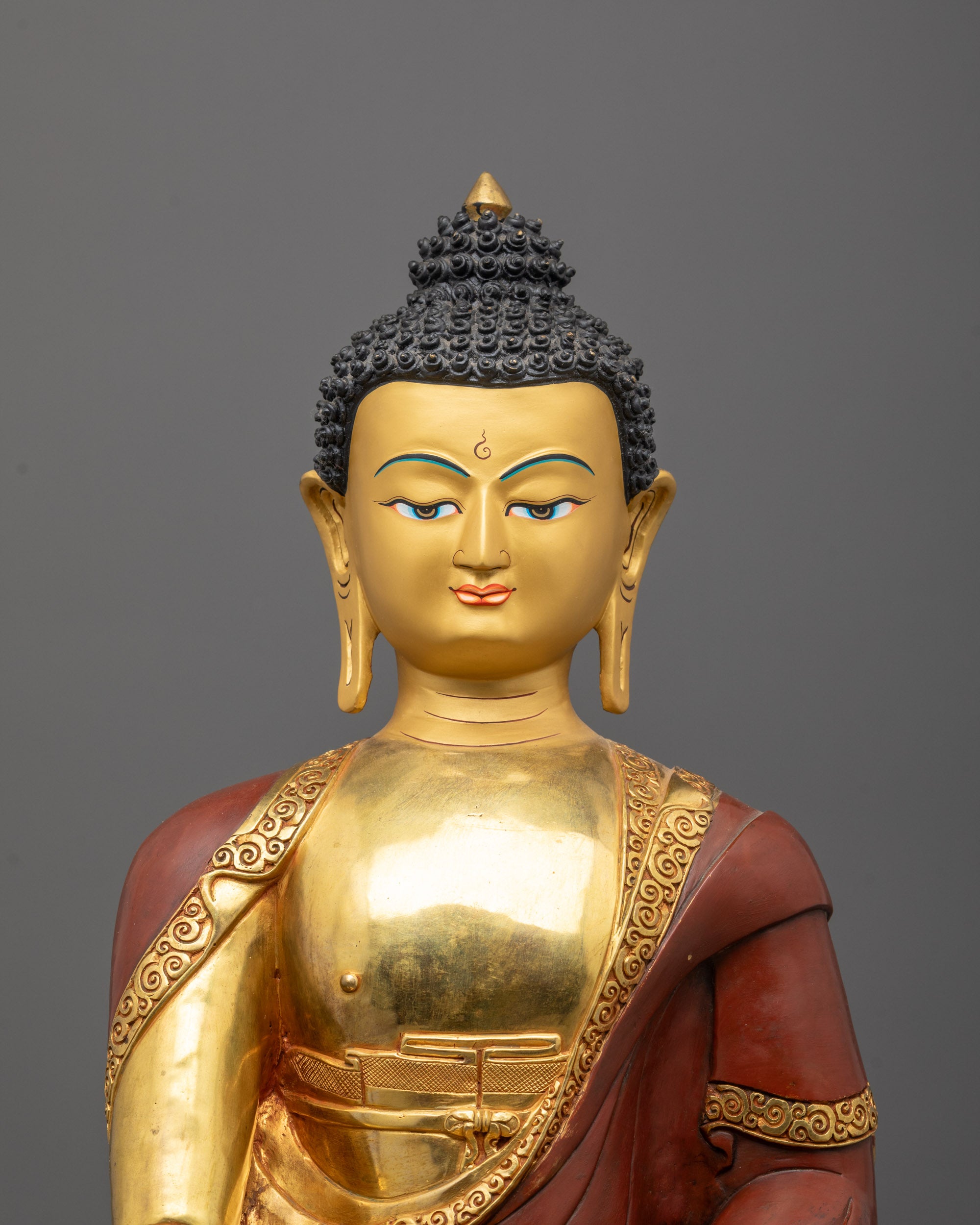Close-up of Shakyamuni Buddha face with 24k fire gold gilded finish