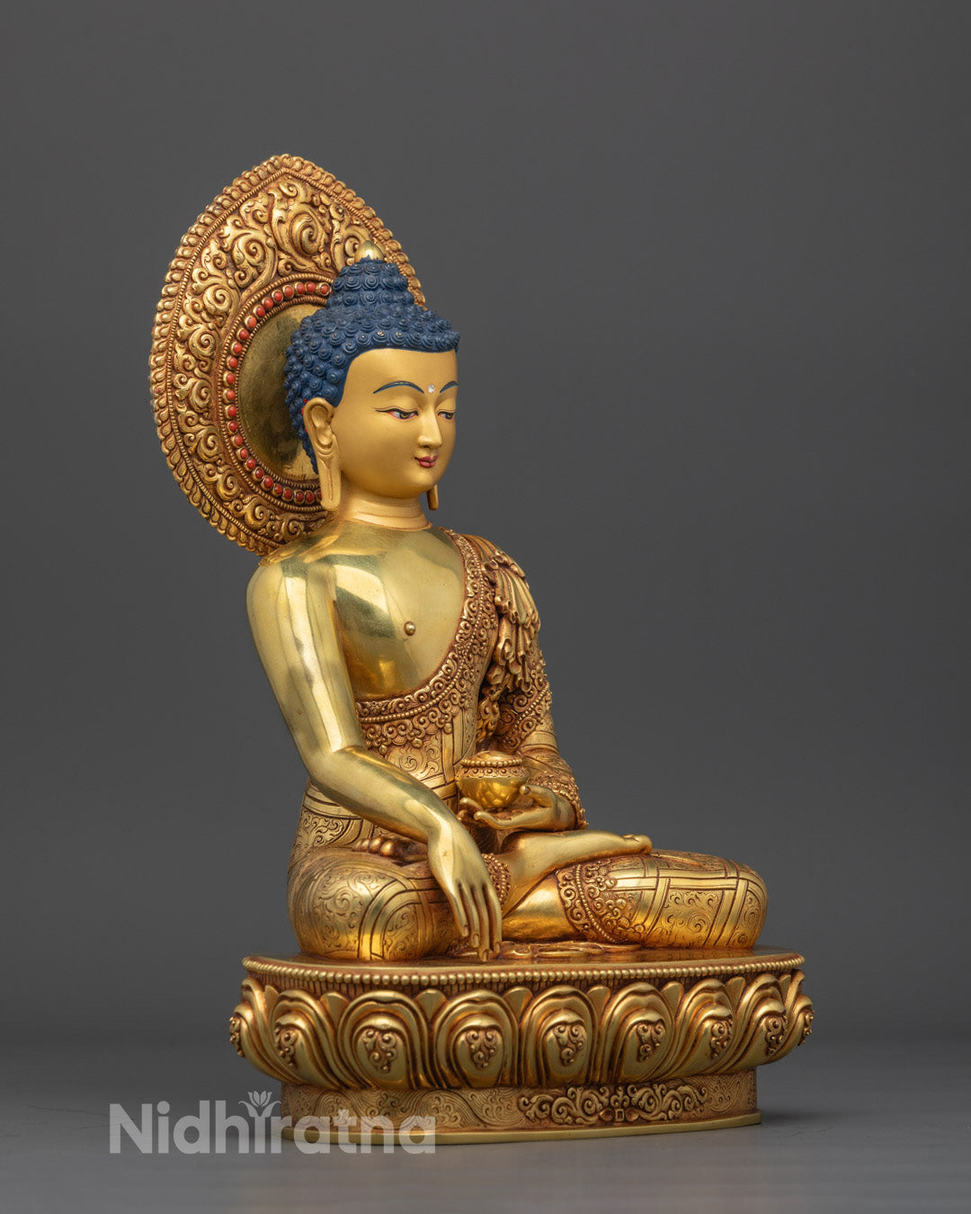 Detailed craftsmanship highlighting the serene expression, 24k gold fire gilding, and spiritual aura of the historical Buddha, Siddhartha Gautama.