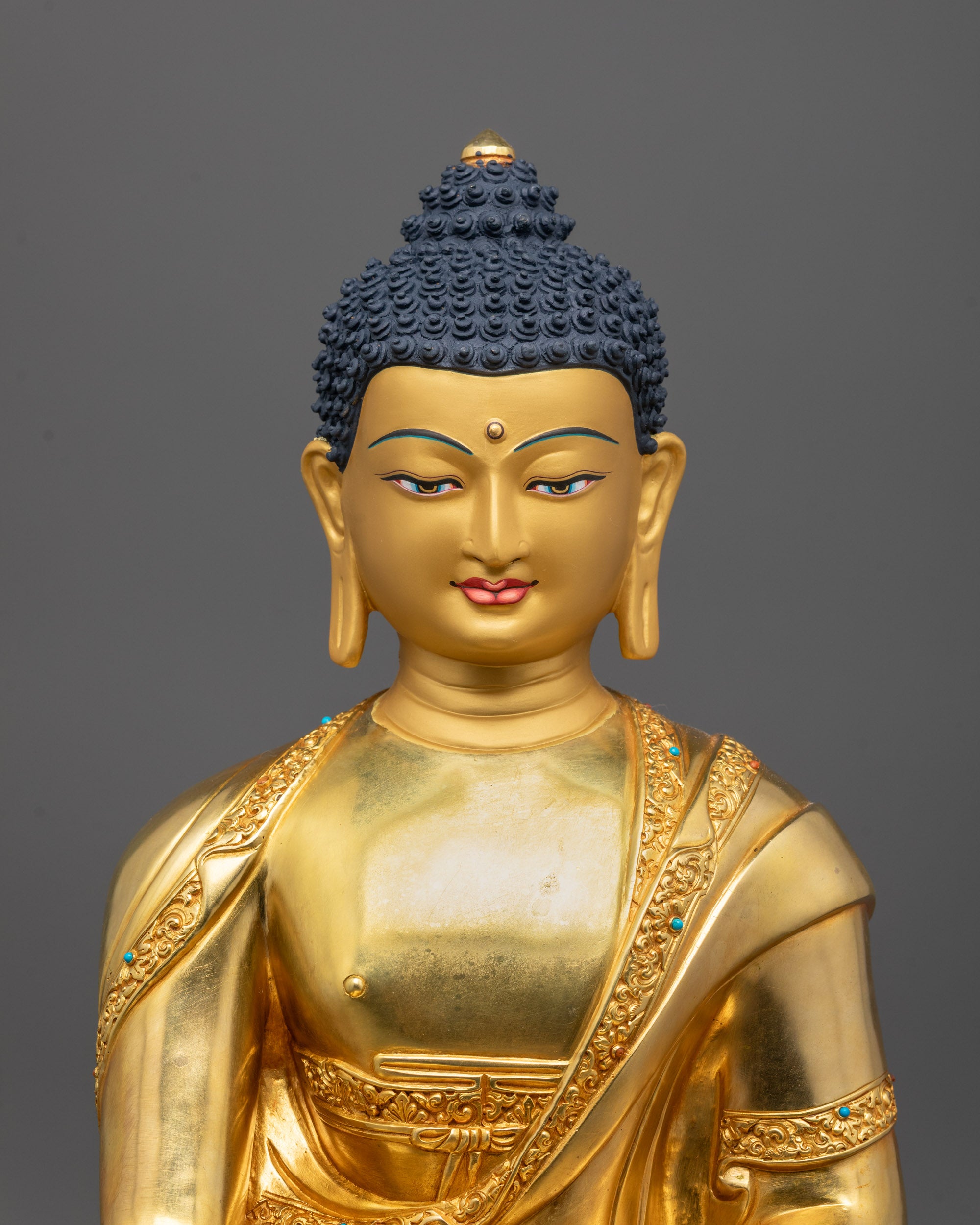 Close-up of Shakyamuni Buddha’s face polished with pure 24k gold showing