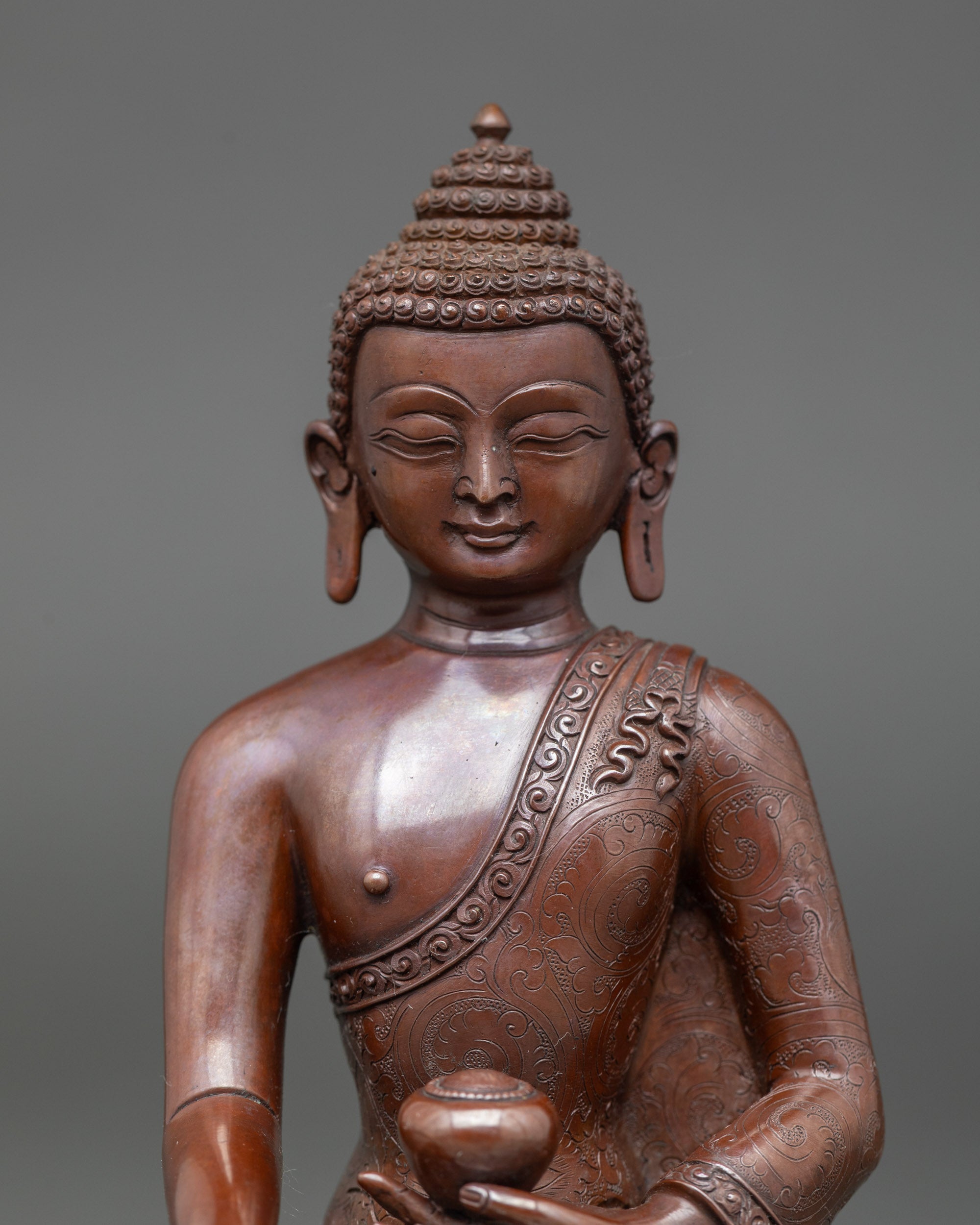 Close-up of Shakyamuni Buddha's face showing a serene expression and a monk’s bowl
