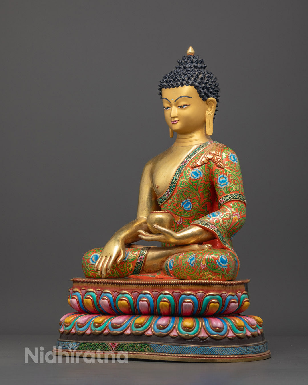 Shakyamuni Buddha’s serene expression and detailed craftsmanship, showcasing rich gold gilding and lotus throne base