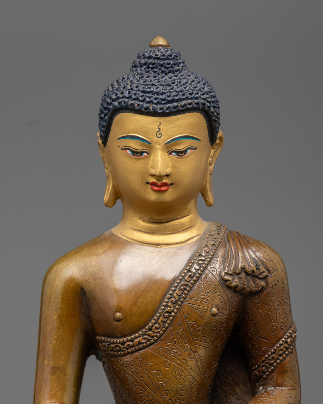 Close-up of Shakyamuni Buddha’s serene face adorned with 24K gold gilding and traditional Nepali craftsmanship.