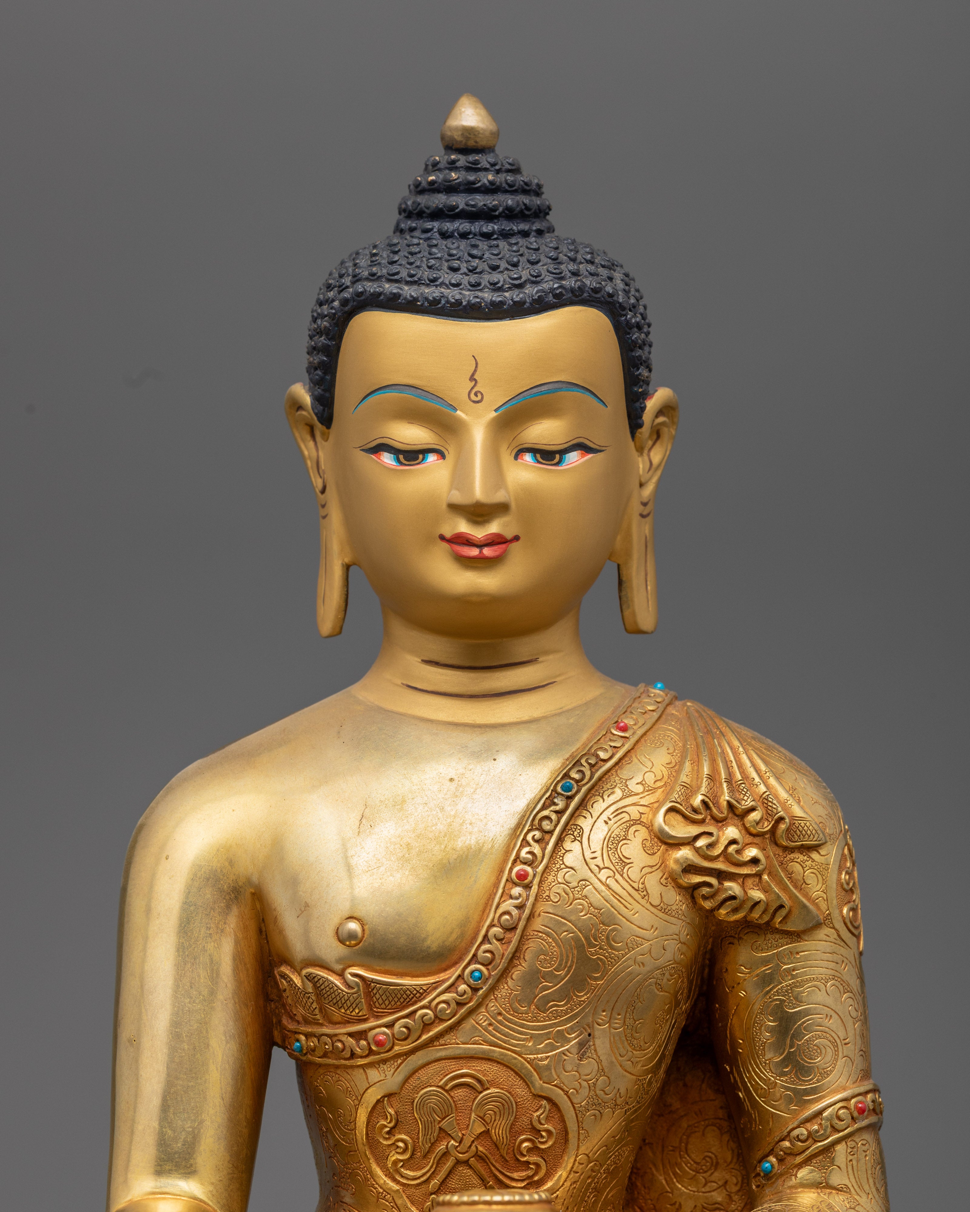 Shakyamuni Buddha’s serene face and upper body, showcasing detailed facial features, gold gilding, and vibrant acrylic colors.