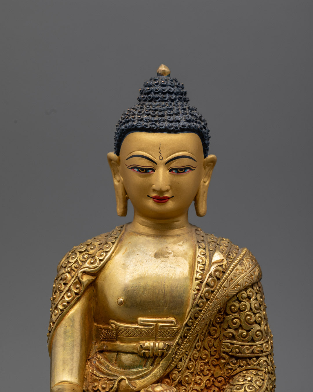 Shakyamuni Buddha sculpture’s intricate details with semi-precious stones and vibrant acrylic colors, highlighting serene facial expression.