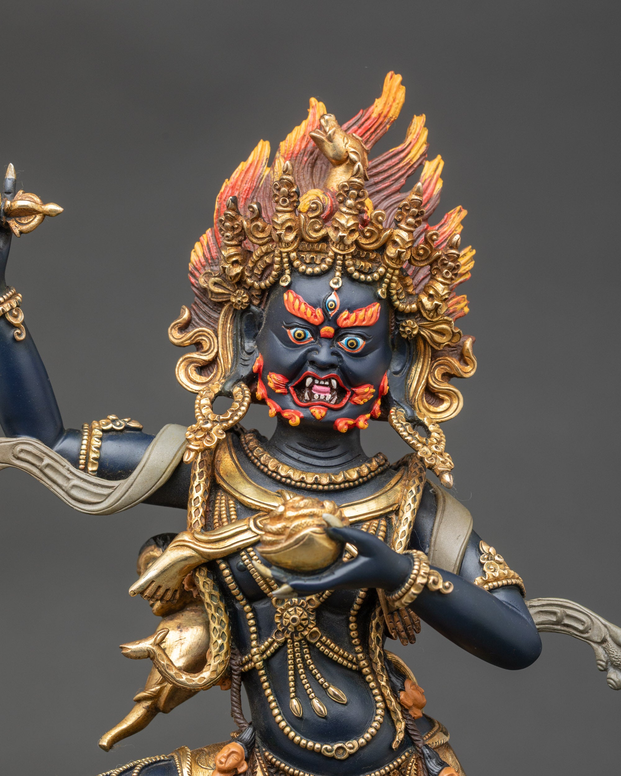 Close-up of Troma Nagmo statue showing intricate copper and gold details