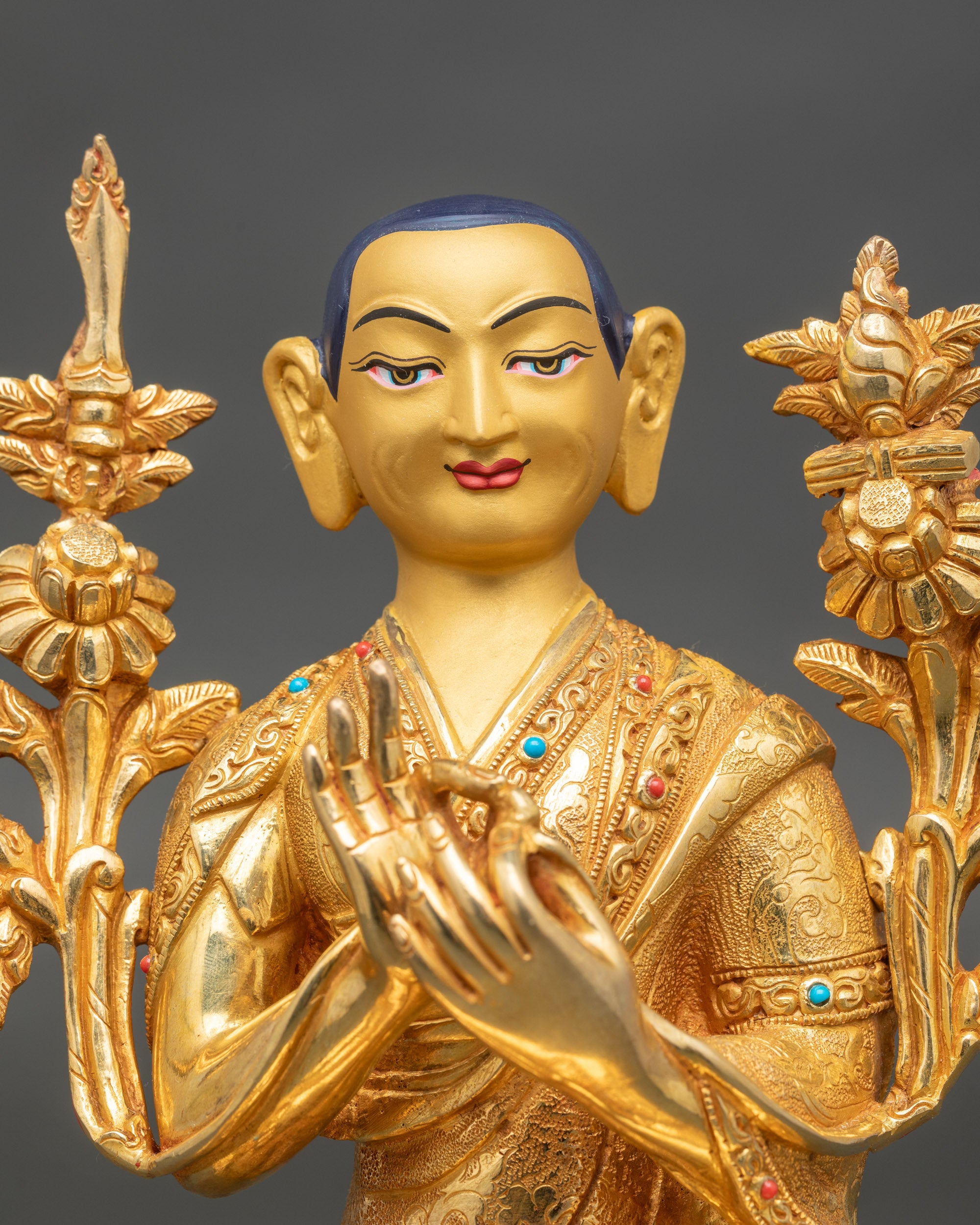 Close-up of Tsongkhapa face with gold-painted details, handcrafted Nepalese Buddhist art