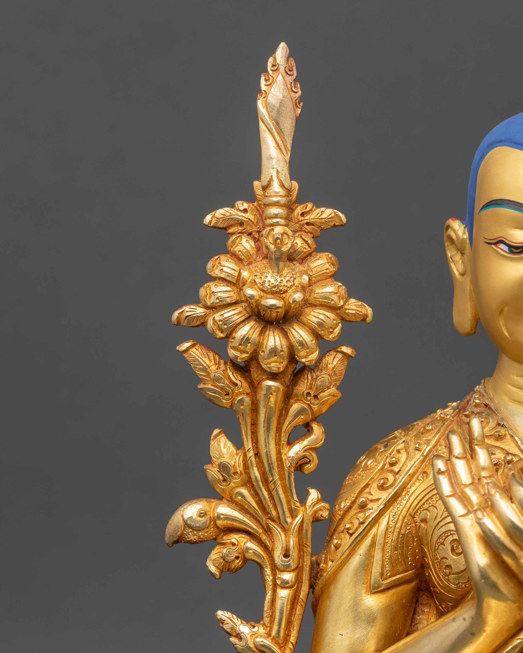 Close-up of Tsongkhapa gold-painted face with detailed fire-gilded finish