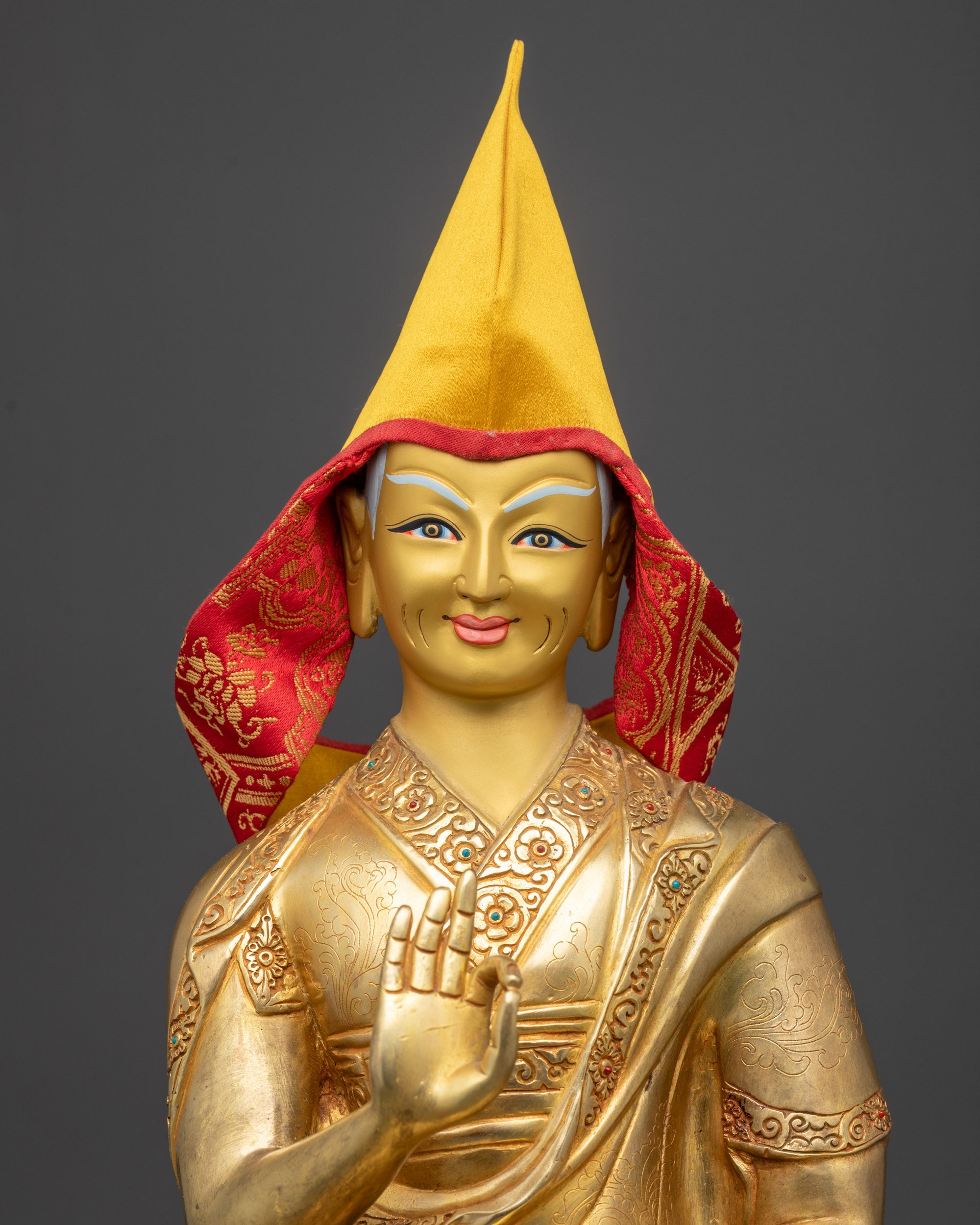 Close-up of Tsongkhapa's yellow Pandita hat with red inner lining, symbolizing spiritual wisdom in Tibetan Buddhism.