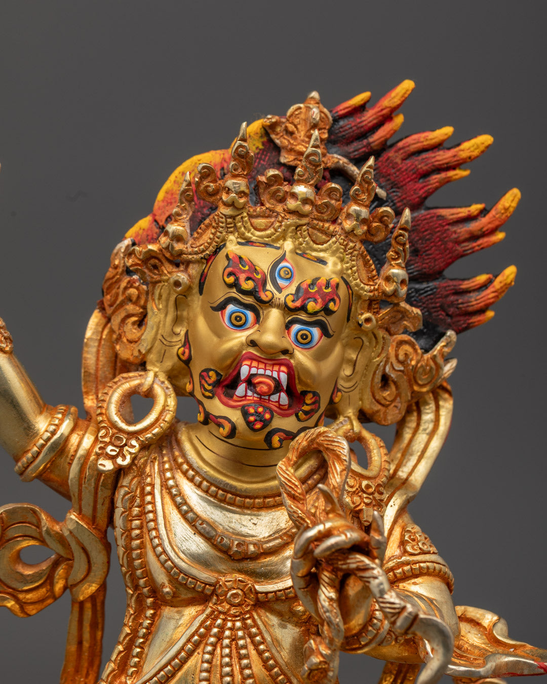 Close-up of Vajrapani holding a diamond scepter (vajra), showcasing intricate acrylic detailing and third eye of wisdom.