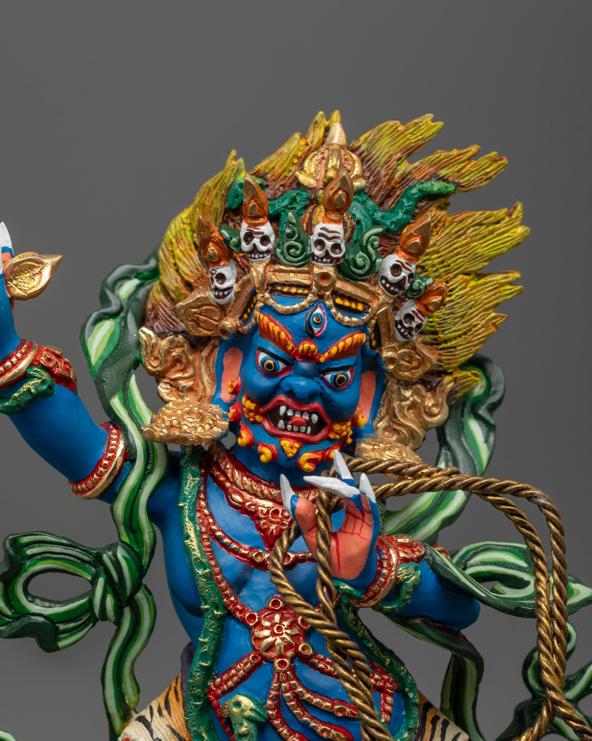 Close-up of Vajrapani holding vajra with fearsome halo and intricate detailing