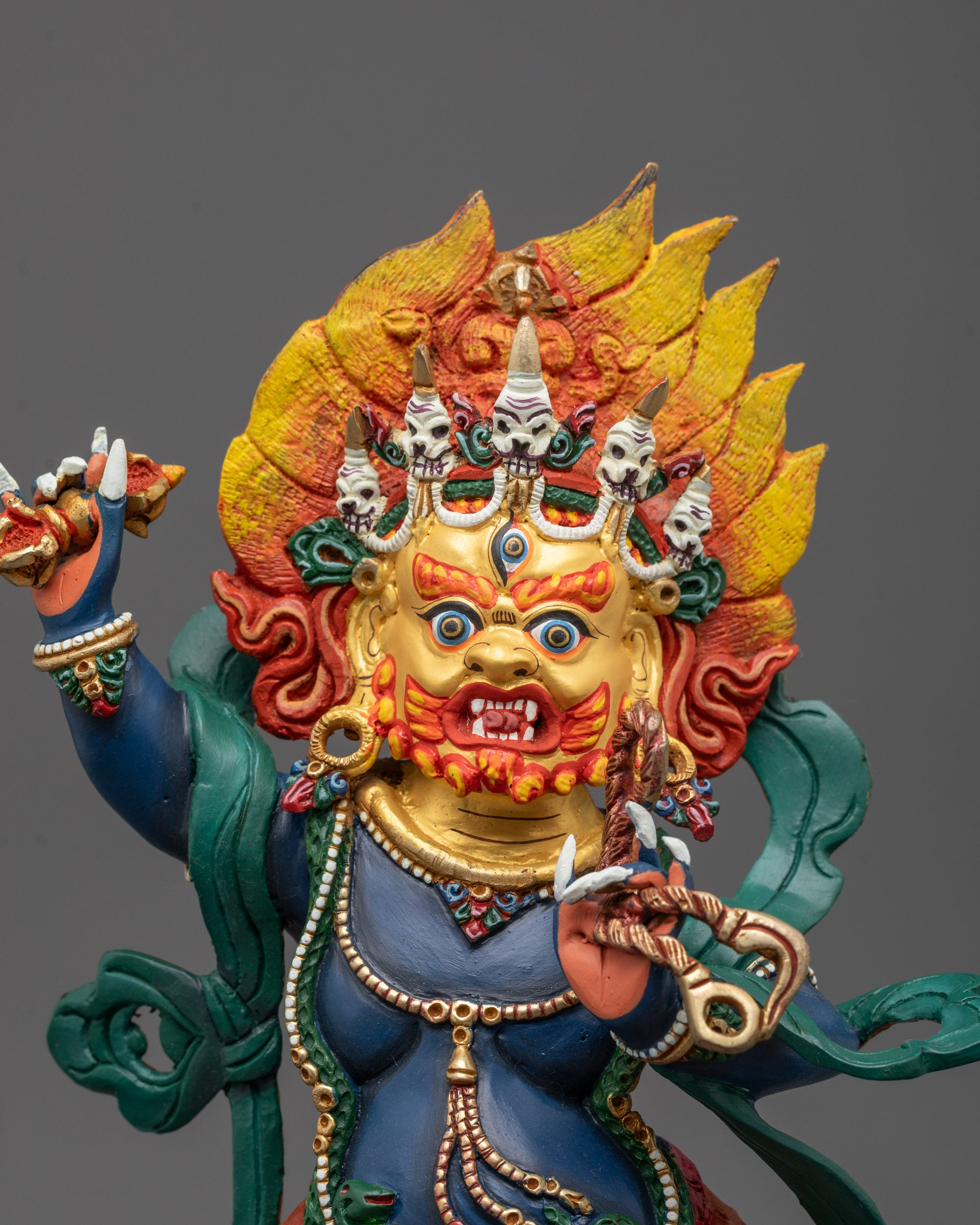 Close-up of Vajrapani’s fierce blue face and detailed crown