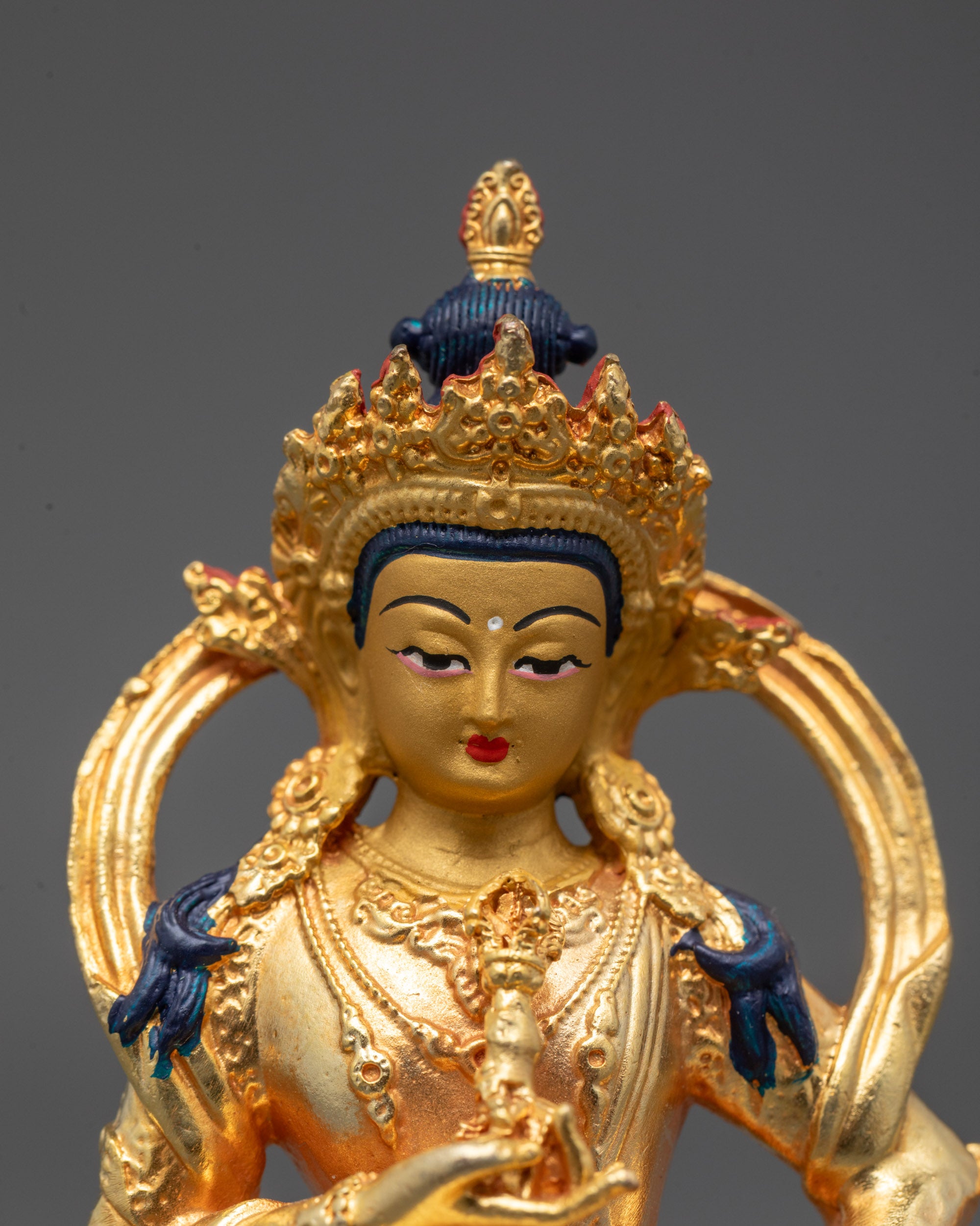 Close-up of Vajrasattva’s serene face and intricate crown, handcrafted in Nepal