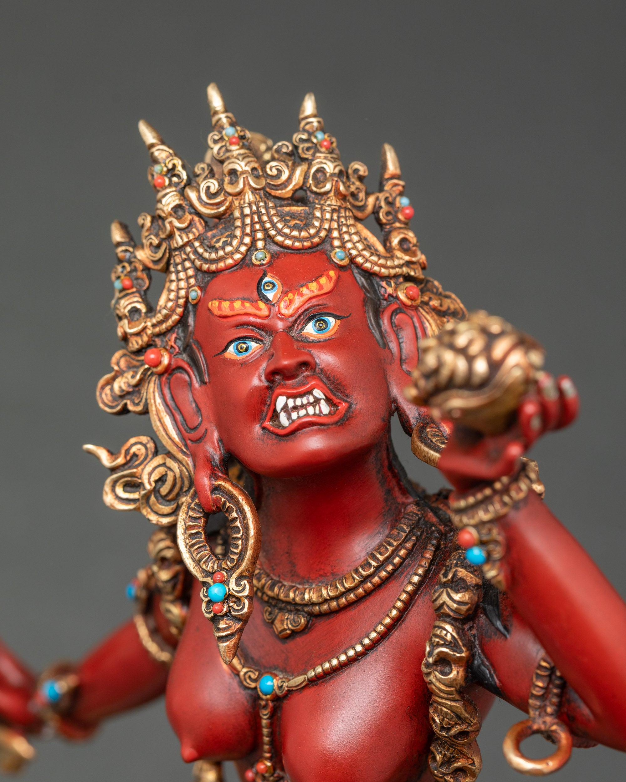 Close-up of Vajrayogini figurine showing intricate copper and gold details