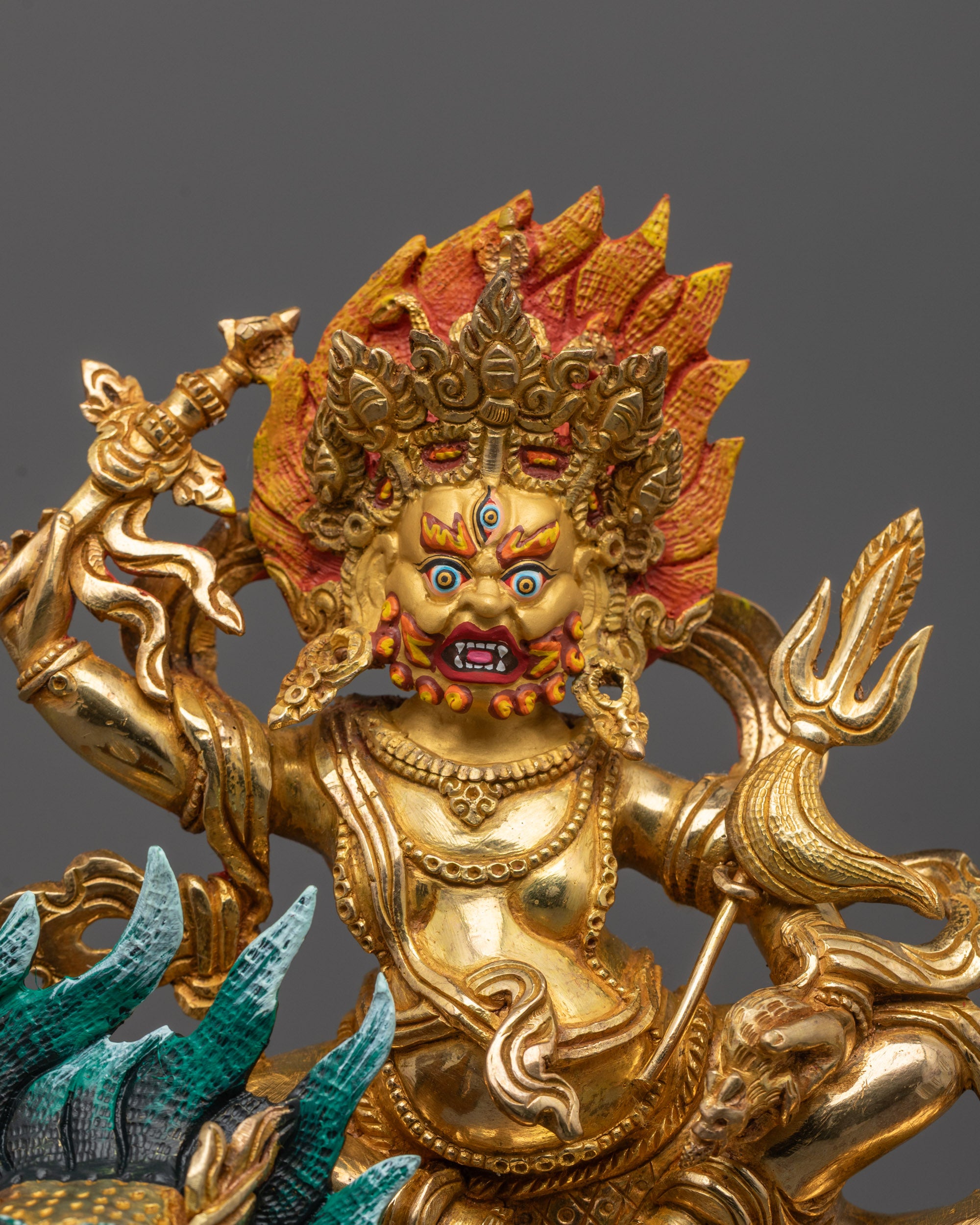 Close-up of White Dzambhala’s face with third eye and 24k gold fire gilded detailing