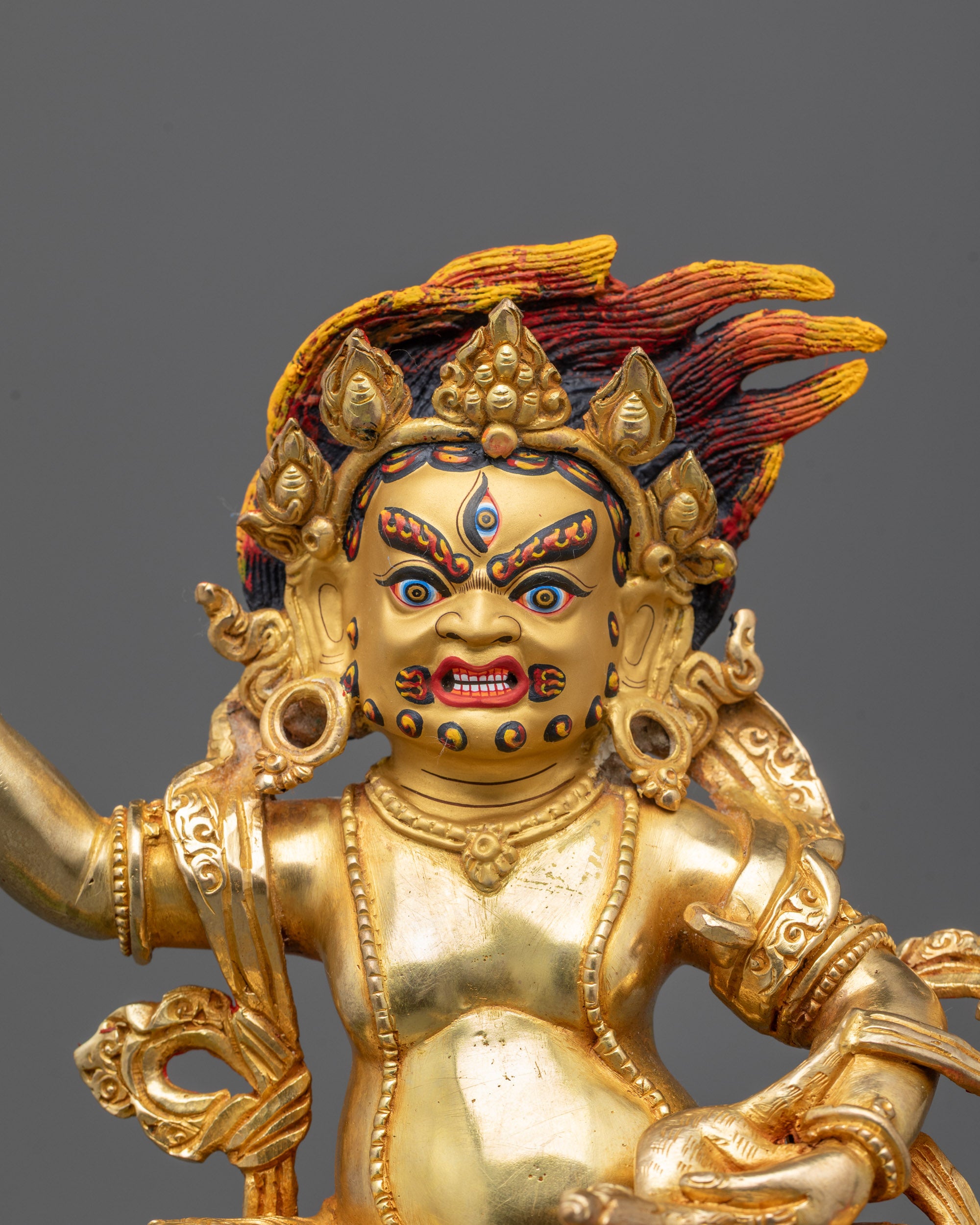 Close-up of White Dzambhala’s serene face and intricate craftsmanship