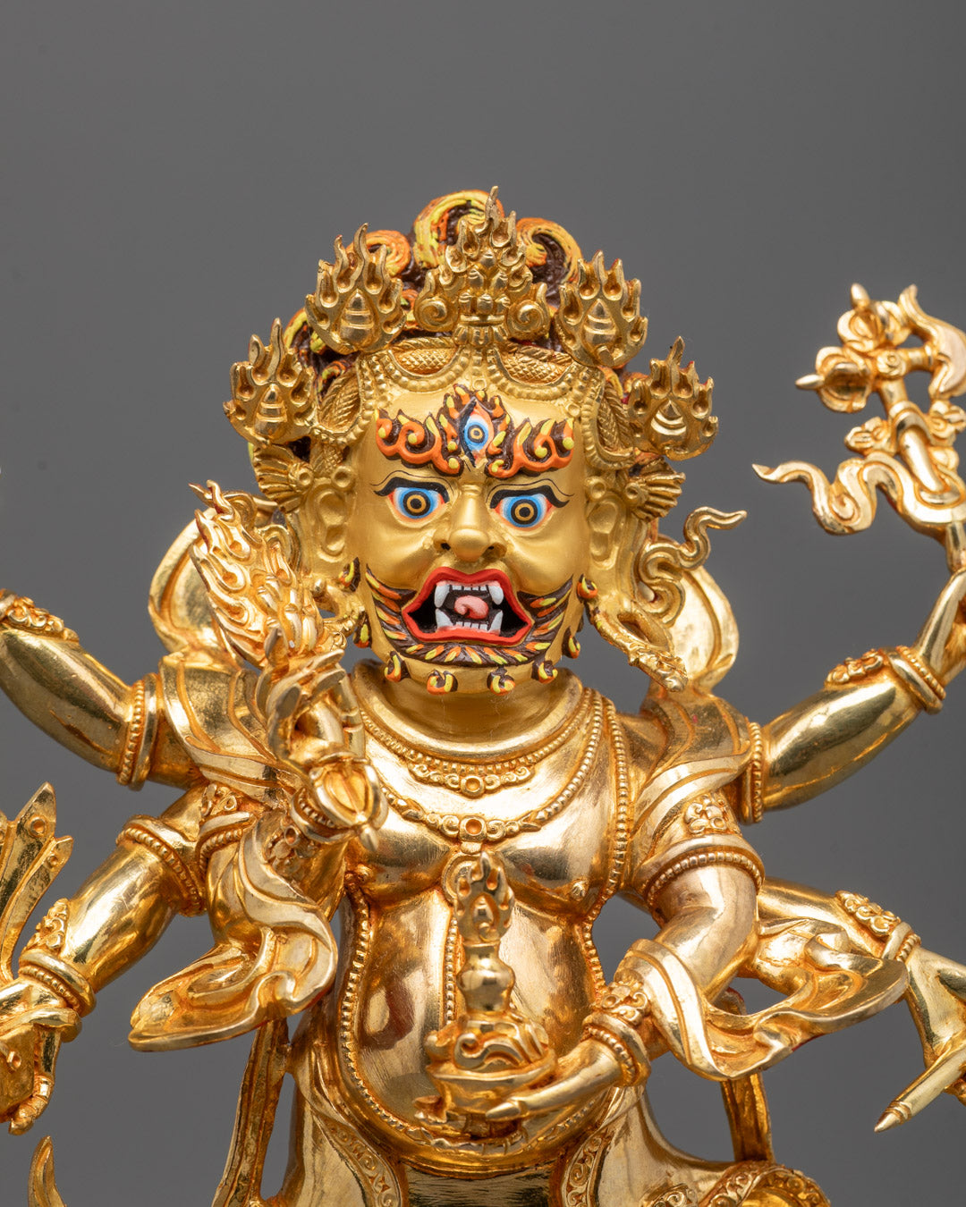 Close-up of White Mahakala's peaceful face and sacred objects held in each hand