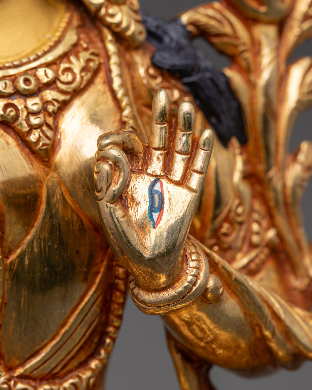 White Tara’s Serene Face with Gold-Gilded Details and Spiritual Symbolism