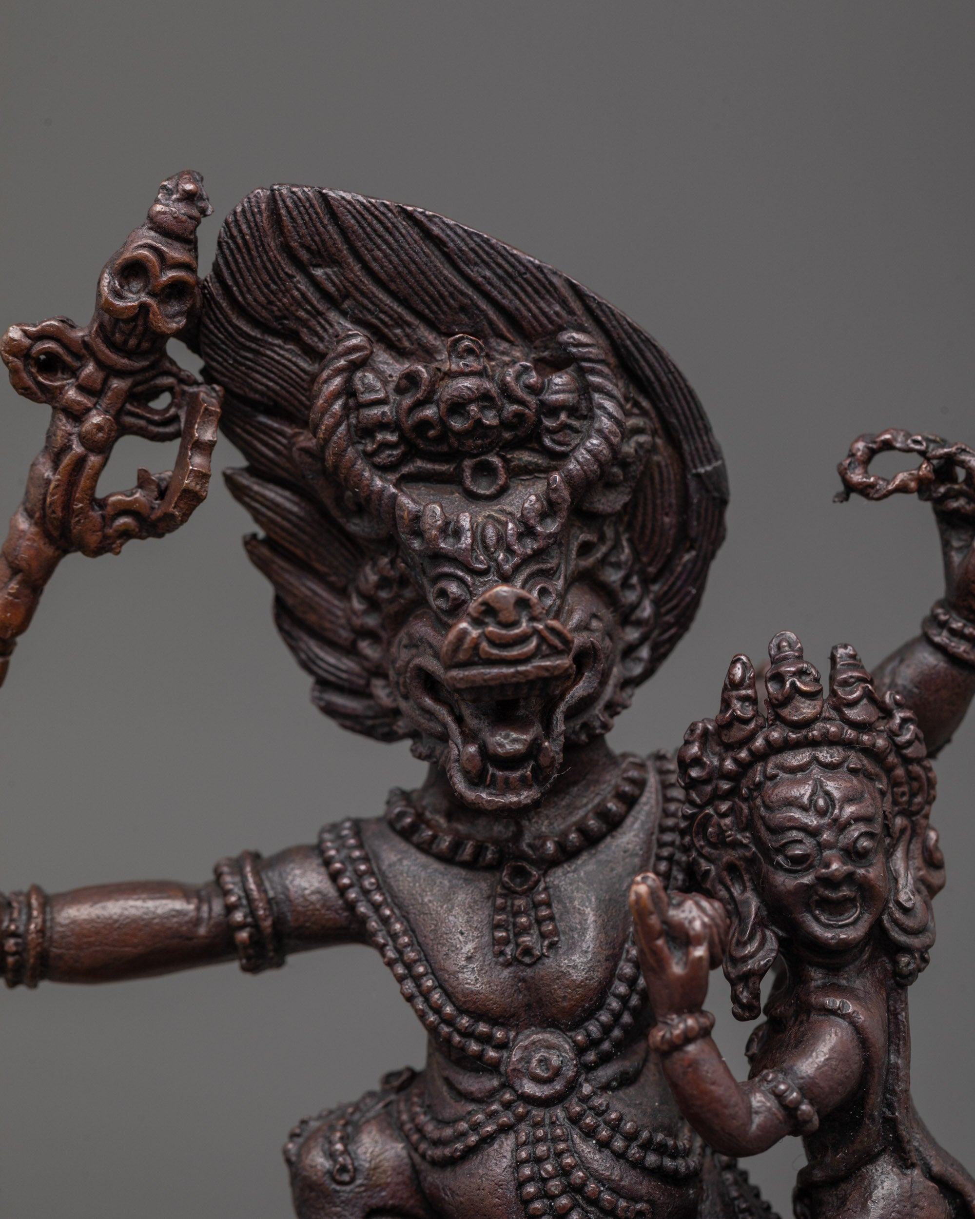 Close-up of Yama Dharmaraja’s fierce face and tantric jewelry, showcasing masterful Nepali carving