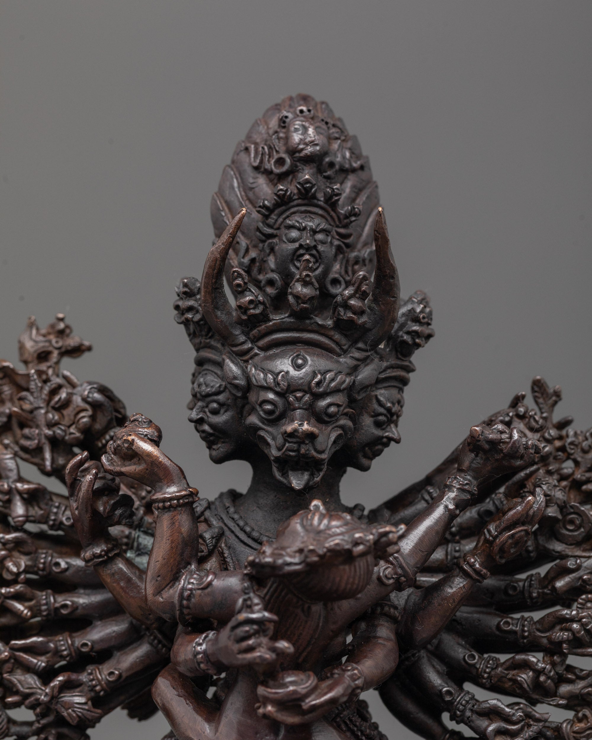 Close-up of Yamantaka face and consort in oxidized copper with ritual detailing