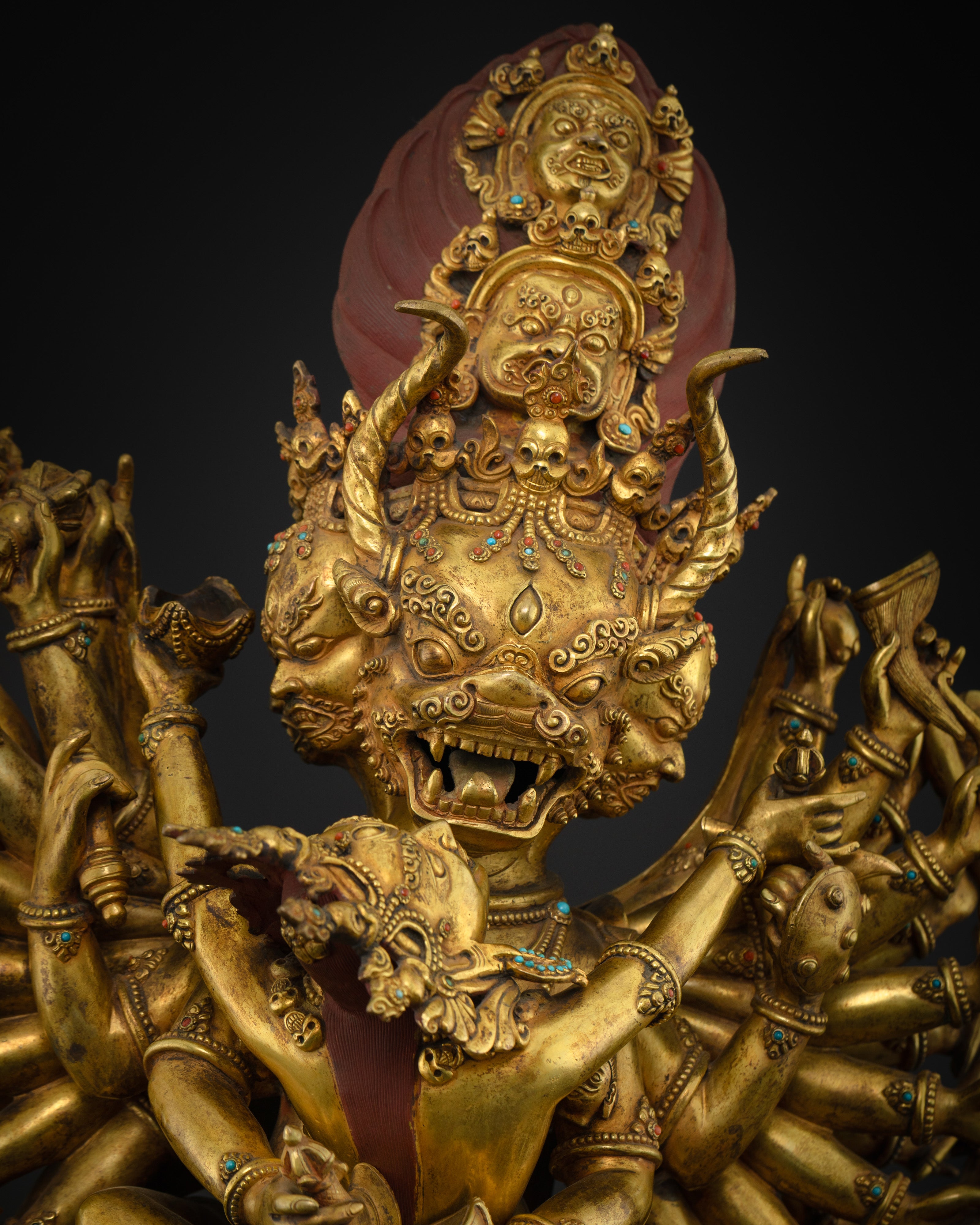 Close-up of Yamantaka’s five fierce faces with skull crown and semi-precious stones detail