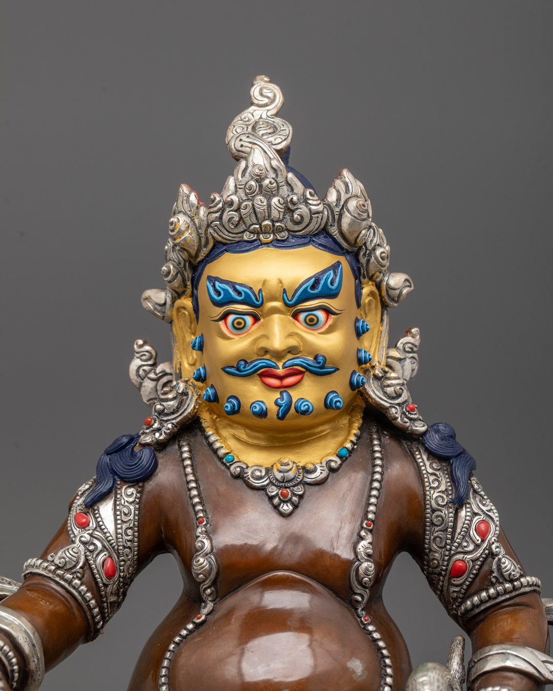 Close-up of intricate carvings on Dzambhala Statue seated on double-layered lotus base