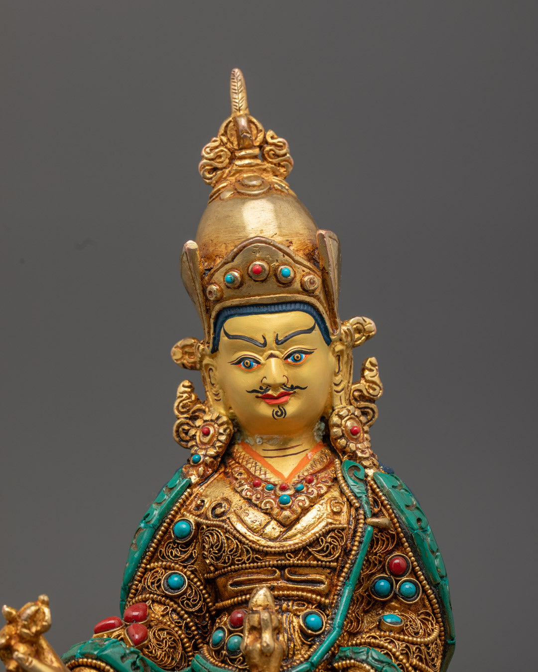 intricate details on the Guru Rinpoche Statue showing vibrant multi-layered acrylic colors and ornate embellishments.