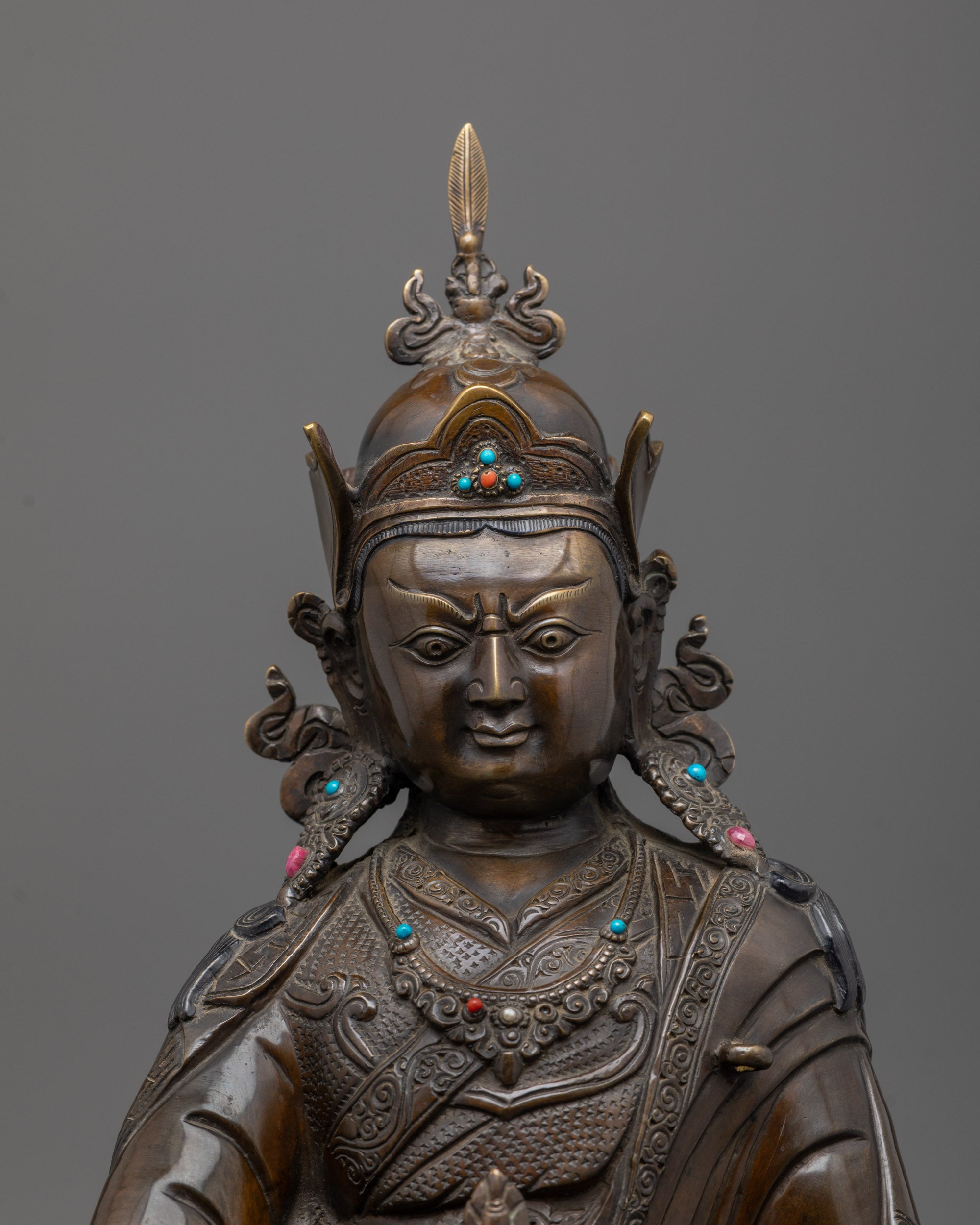 Close-up of oxidized copper face and intricate carvings on Guru Rinpoche Statue