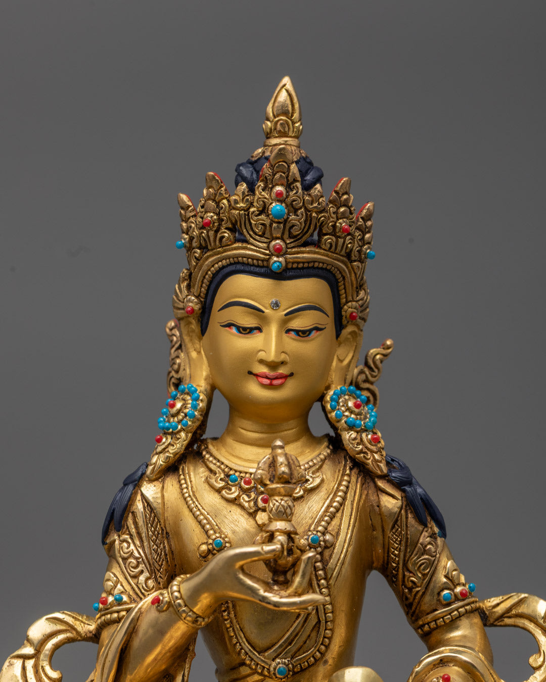 Semi-precious stones adorning the Vajrasattva Statue, highlighting detailed sacred decorations.