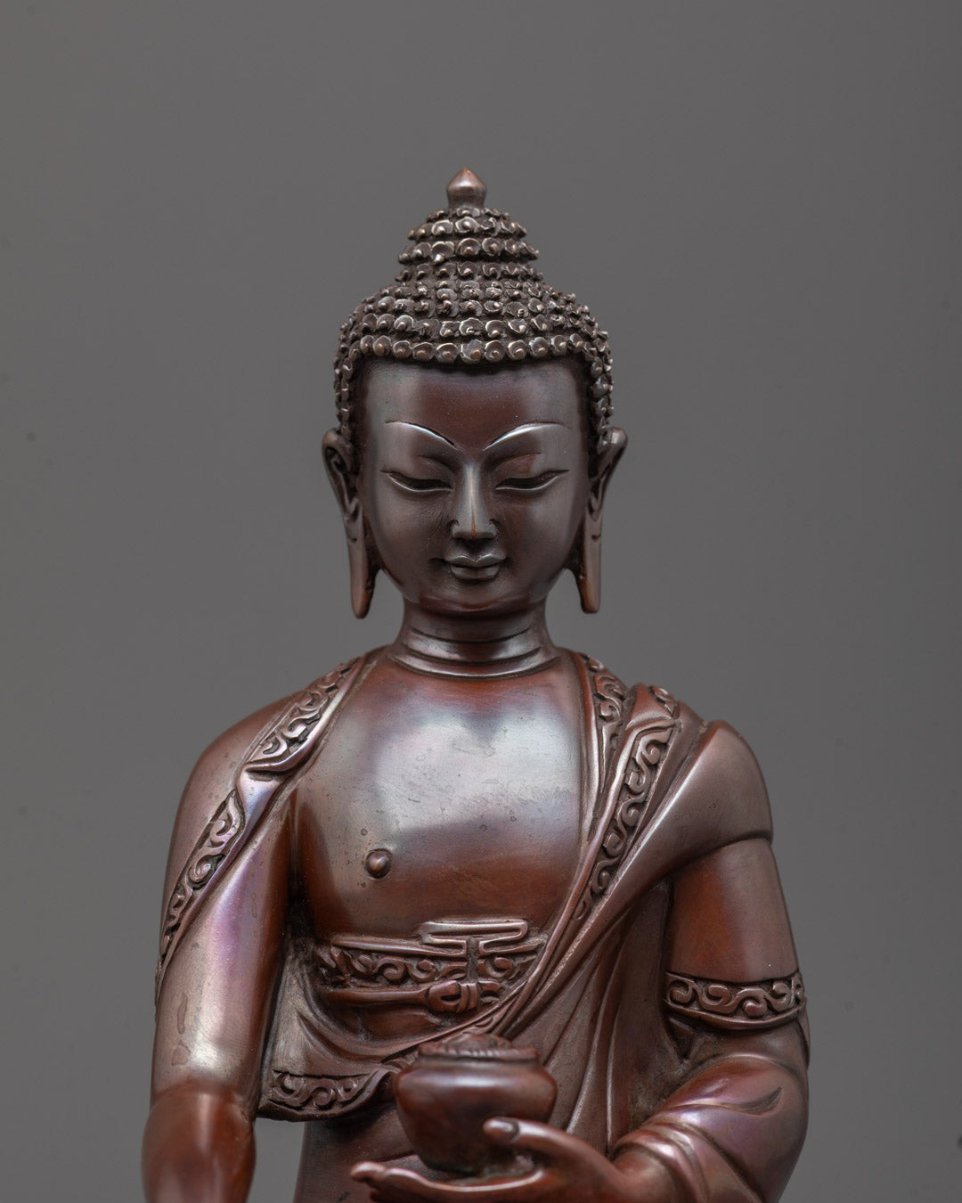Close-up of serene Buddha face with intricate Oxidized Copper