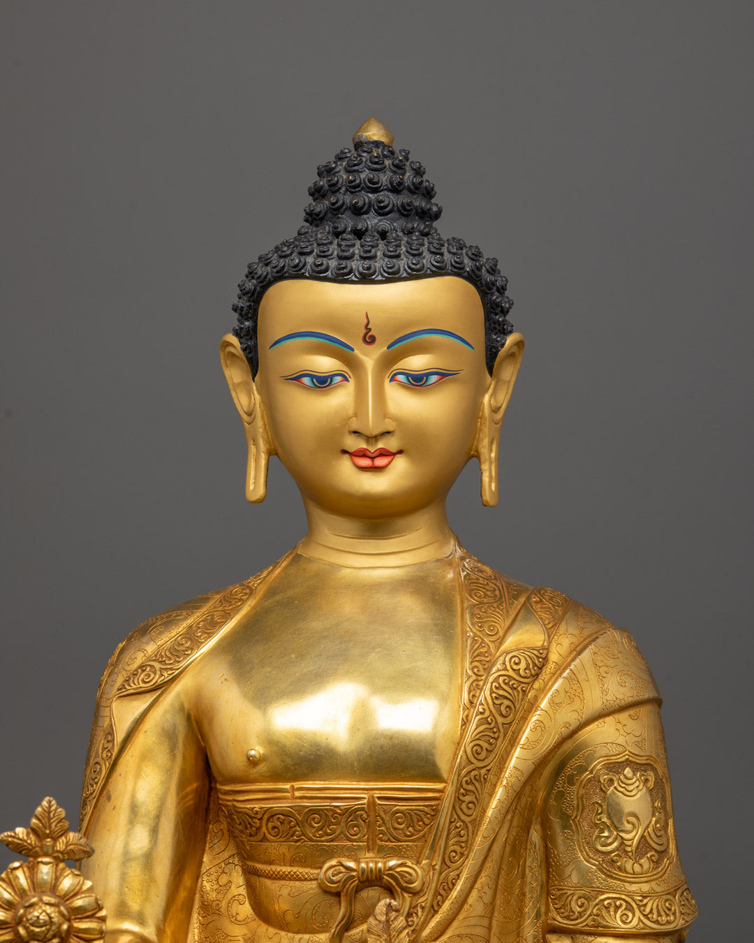 Close-up of serene Buddha face with intricate gold detailing