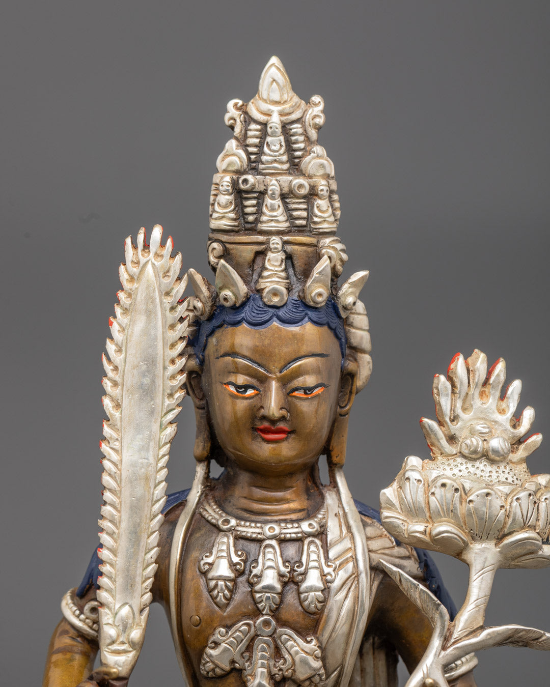 Close-up side angle of lotus flower and jewel held by Akasagarbha Bodhisattva statue