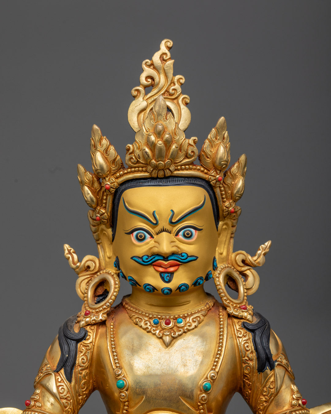 Dzambhala Statue highlighting the gold fire gilded body and intricately crafted face made from precious stones.