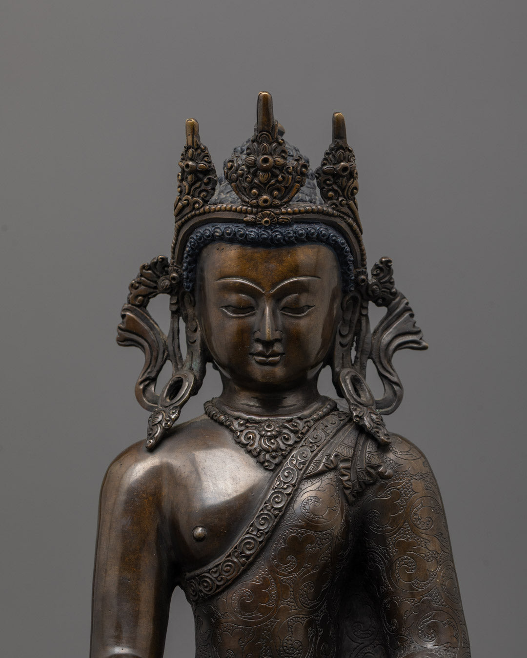 Close up 24k gold fire-gilded Shakyamuni Buddha sculpture holding monk's bowl