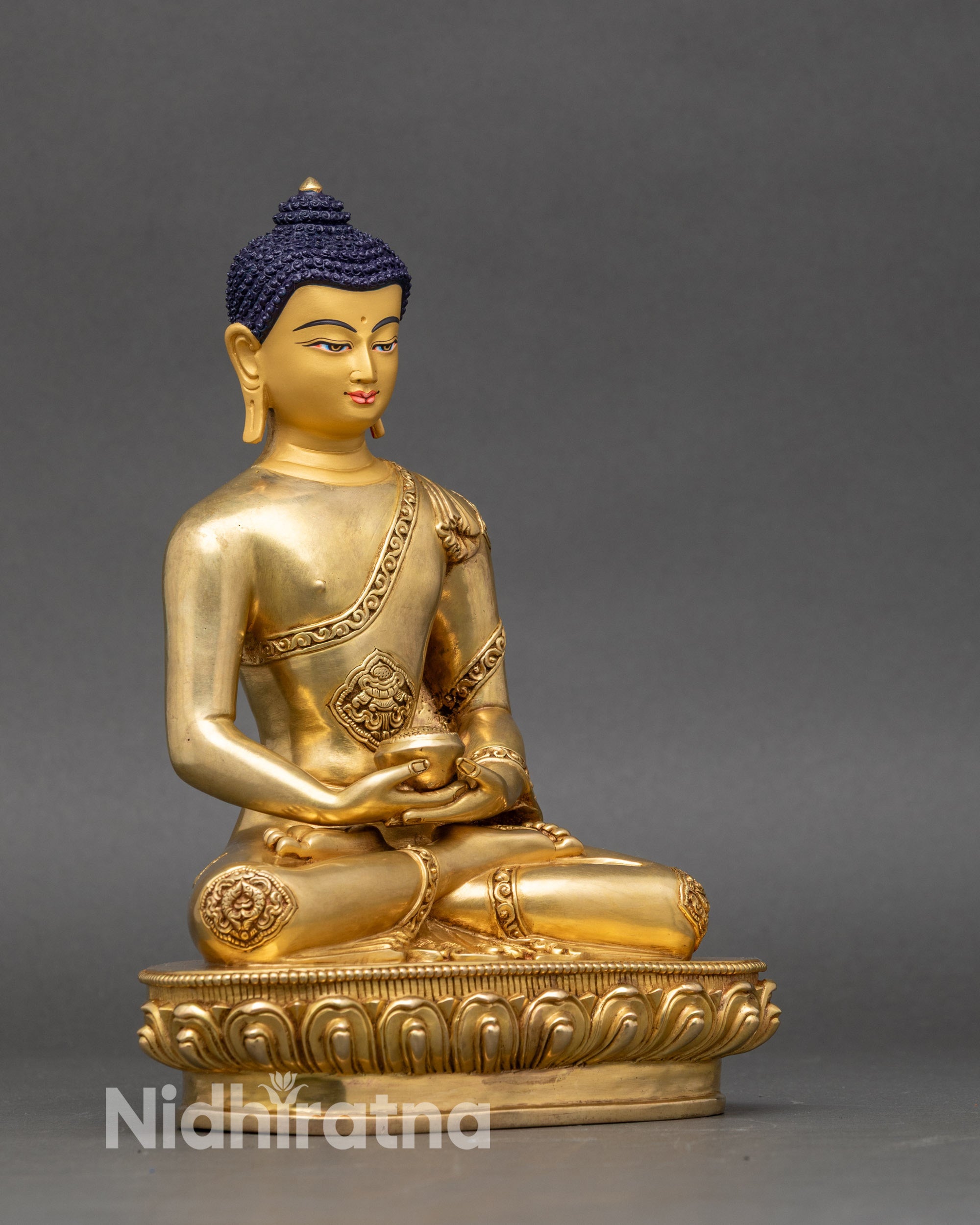 Close up Amitabha Buddha statue serene expression monk’s bowl and intricate details