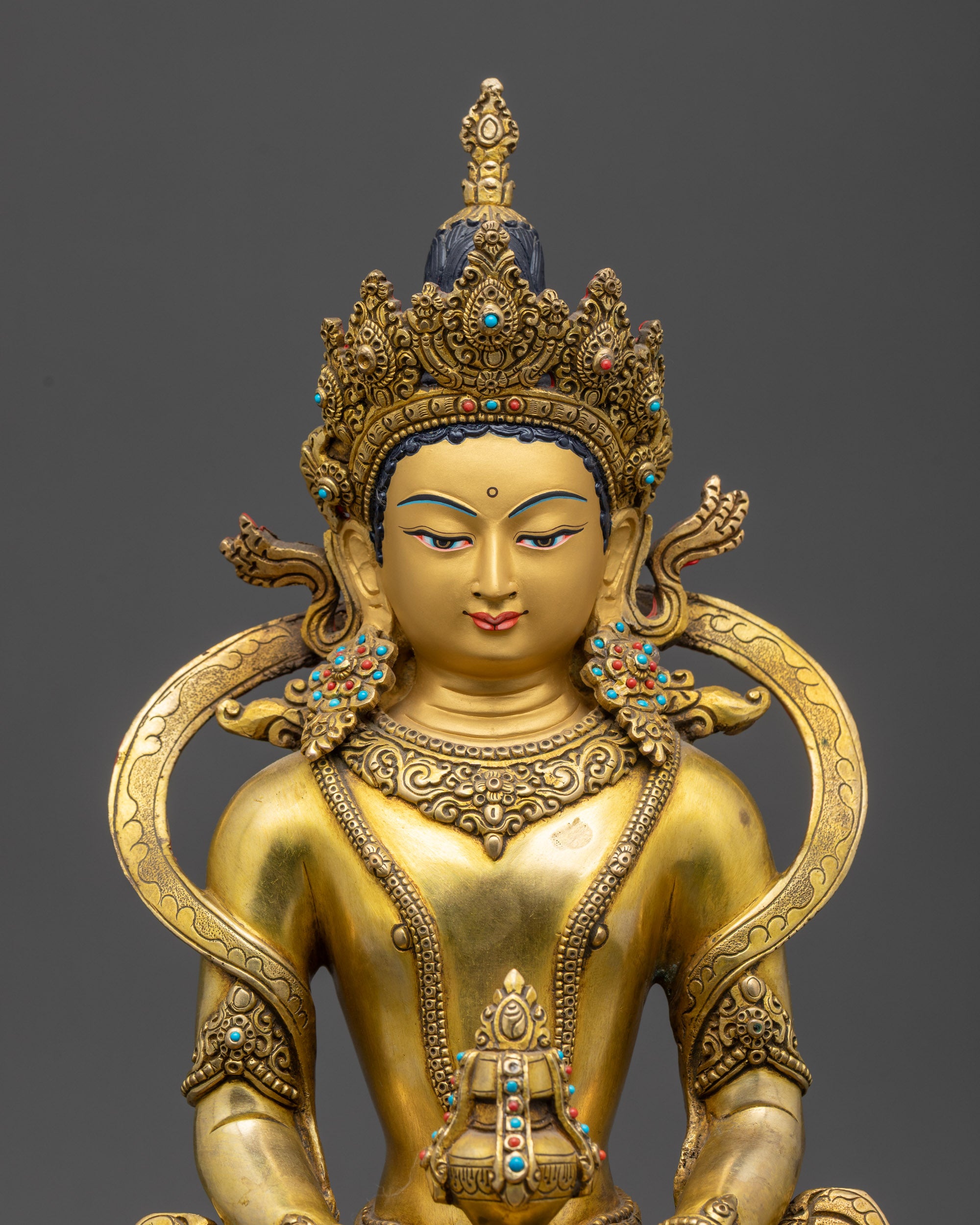 Close up Amitayus Buddha holding nectar vase and wearing five-jeweled crown