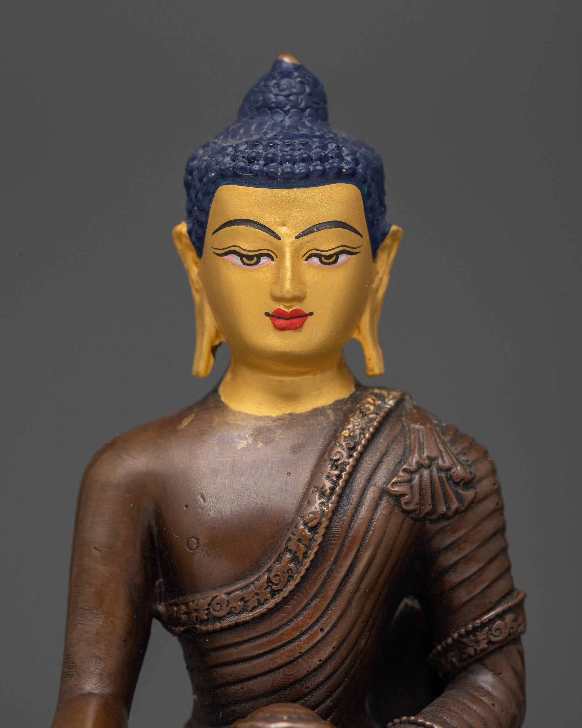 serene face with gold-painted detail