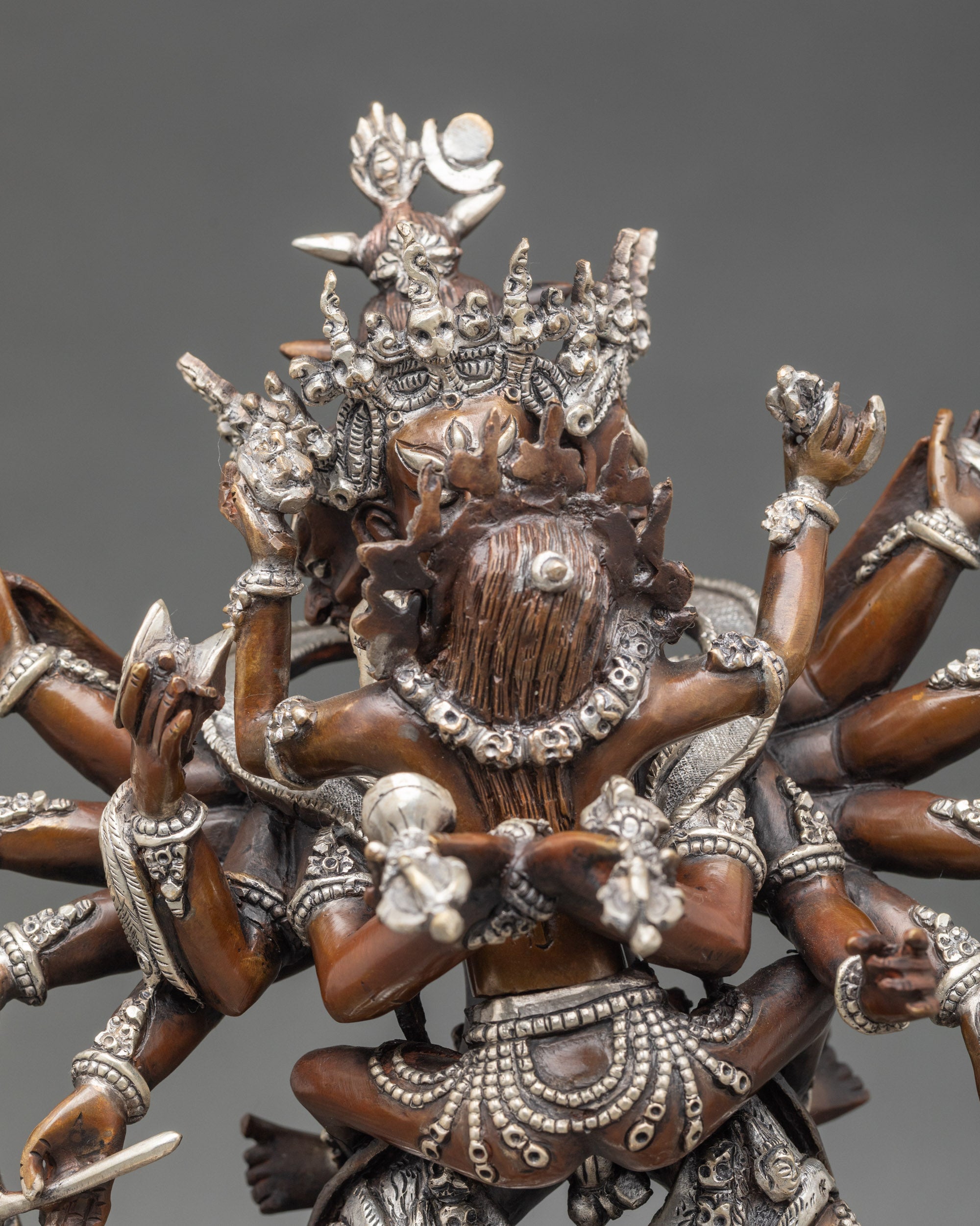 Close up Chakrasamvara four faces twelve arms silver-plated jewelry details
