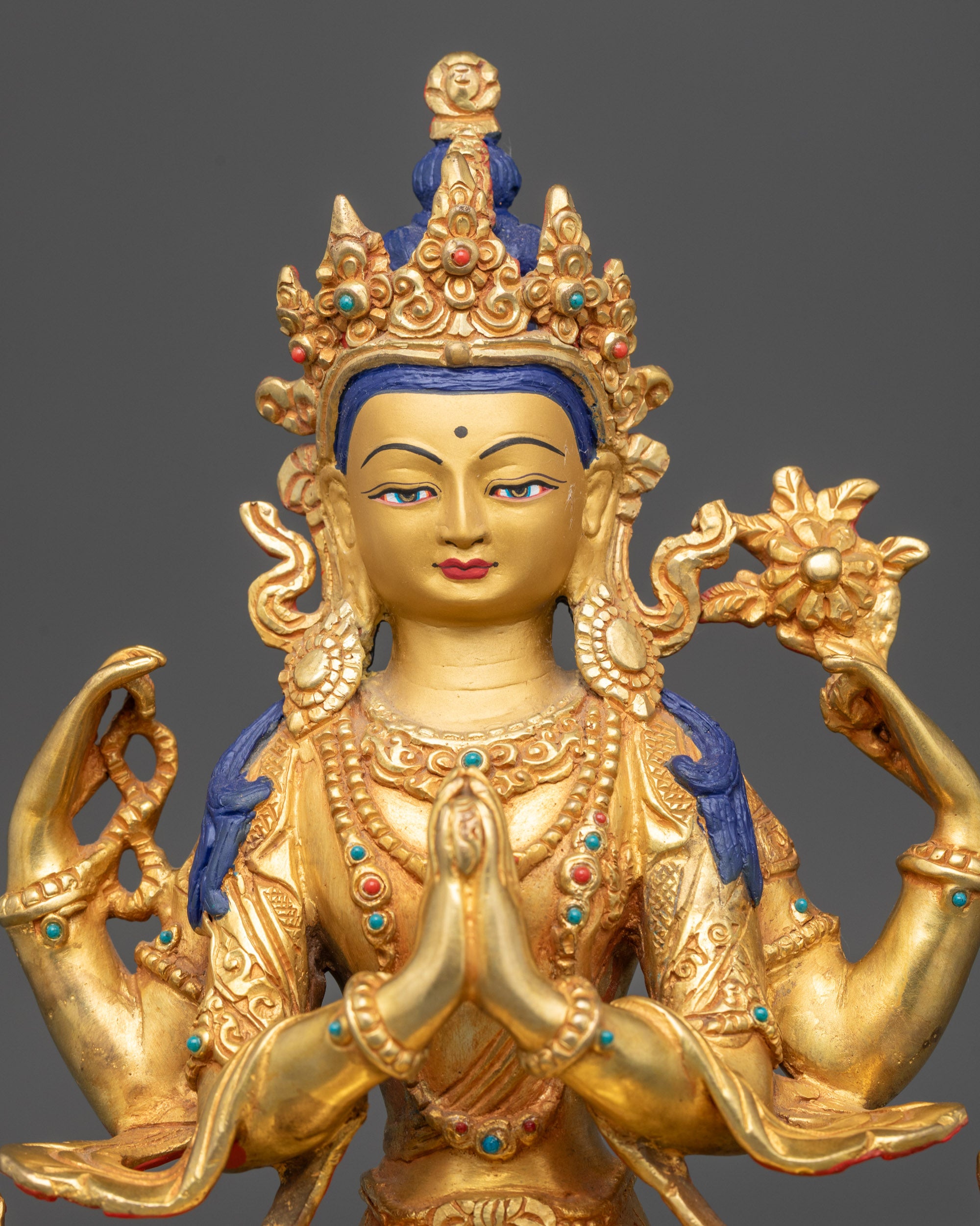 Close up Chenrezig face with five-jeweled crown and ornate earrings