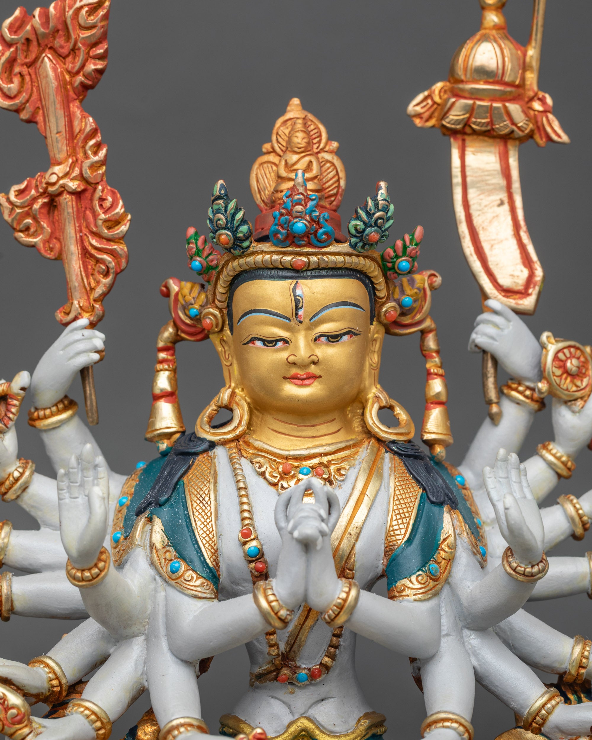 Close up: Close up of Chundi face, gold-painted, jeweled crown, hand-painted vibrant details