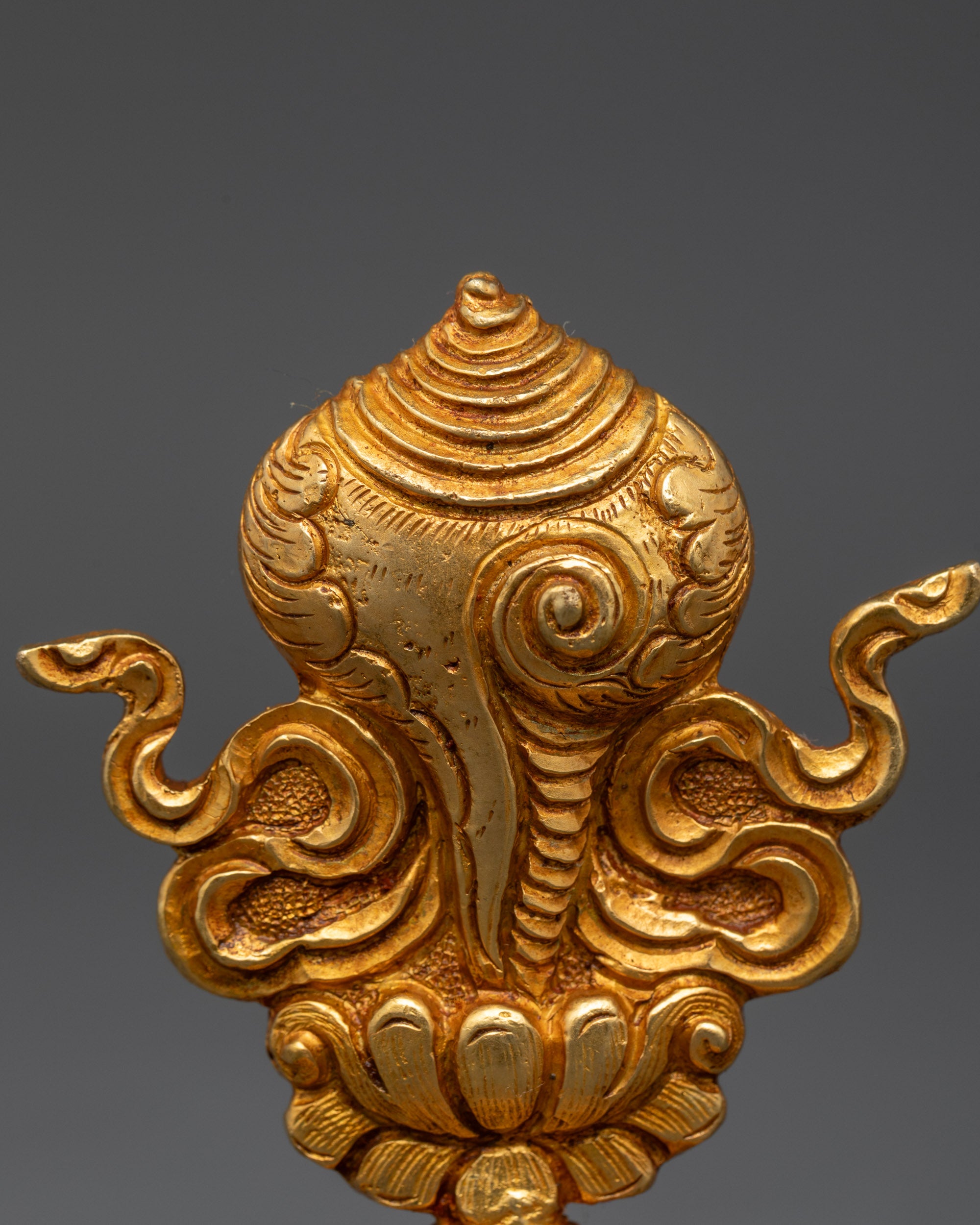 Close up Conch Shell symbol | Gold-gilded Tibetan auspicious object