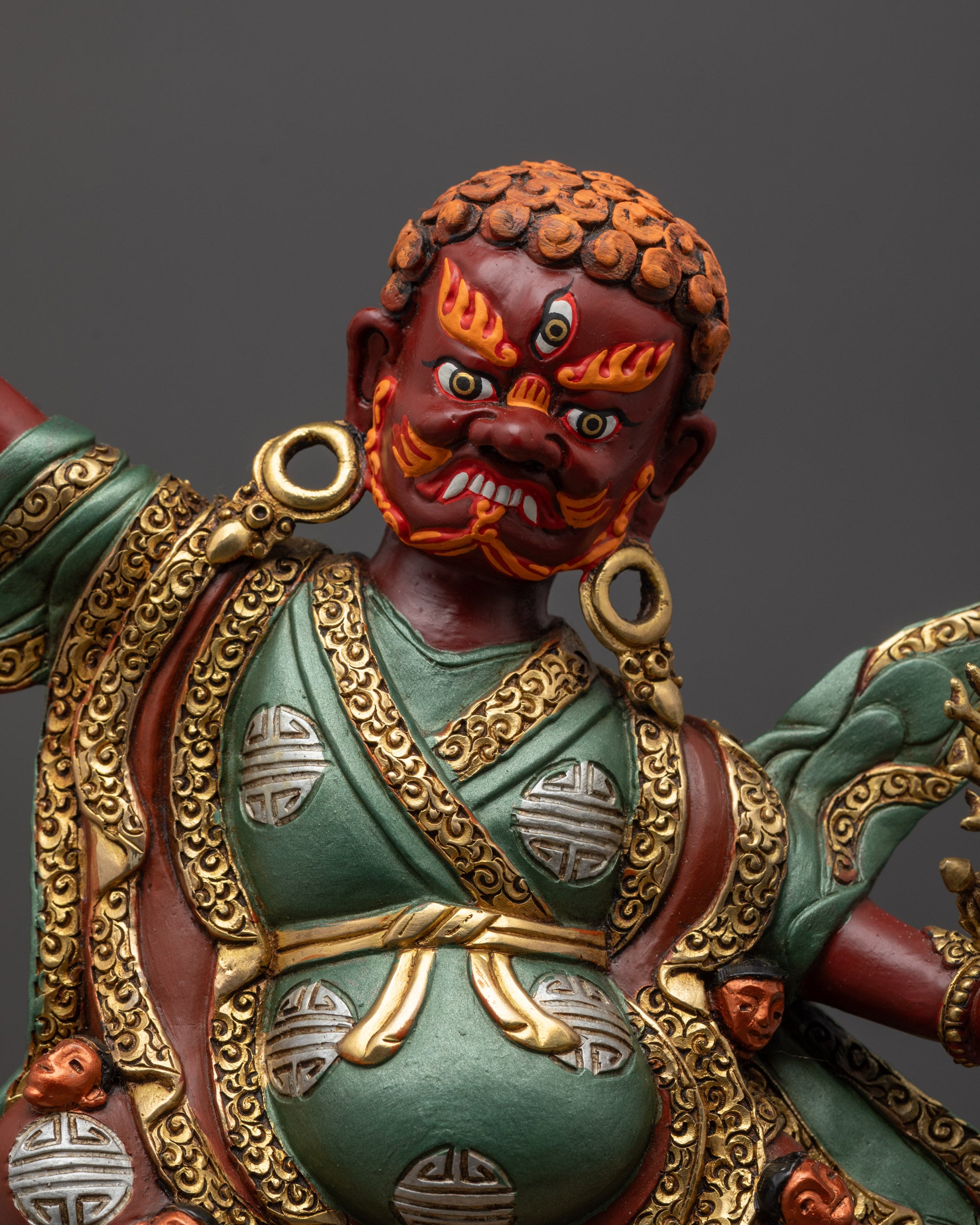 Close up Dorje Drolo statue showing intricate robe and Vajrayana carvings