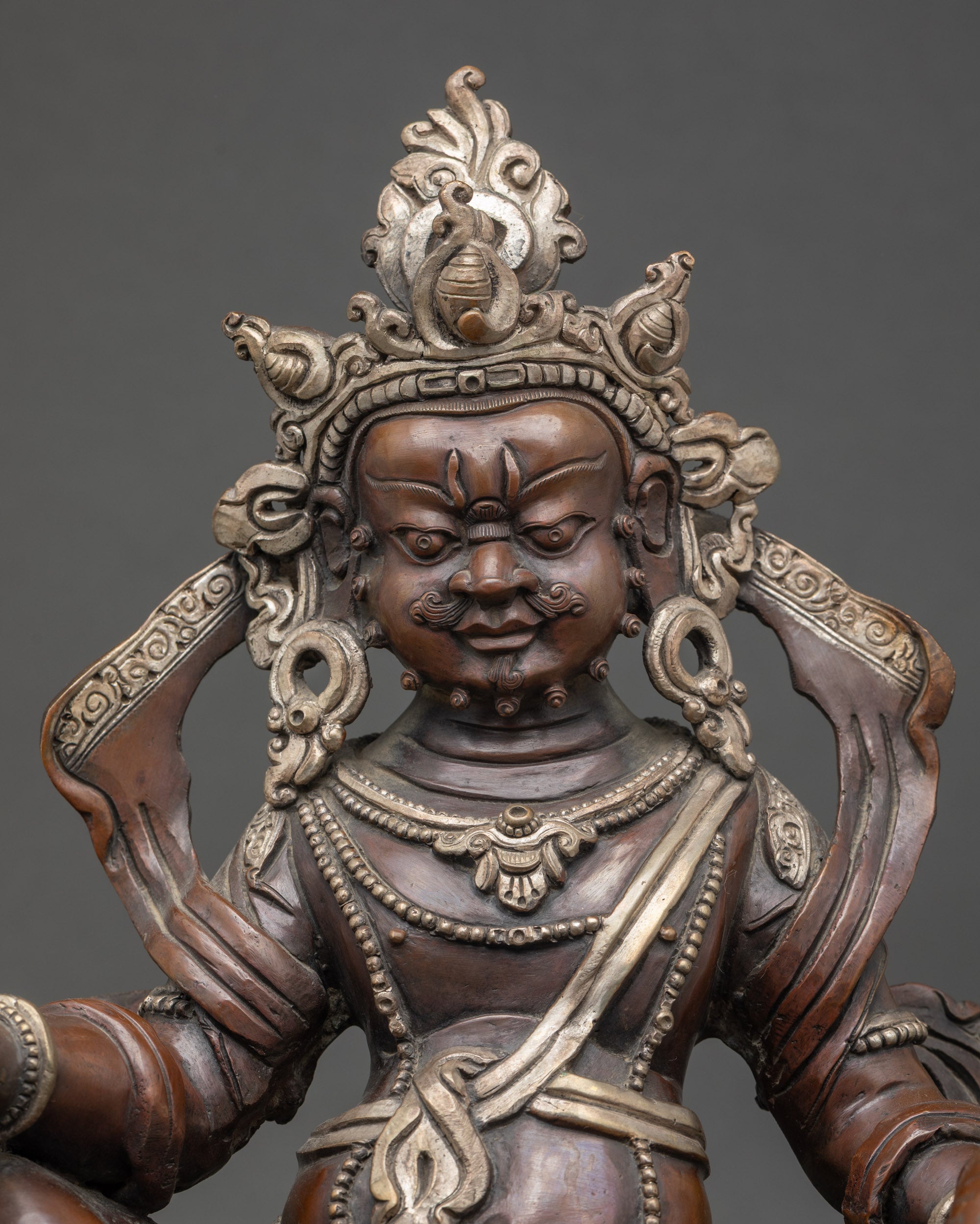 Close up Dzambhala statue | Citron fruits, jewels, and intricate silver-plated craftsmanship