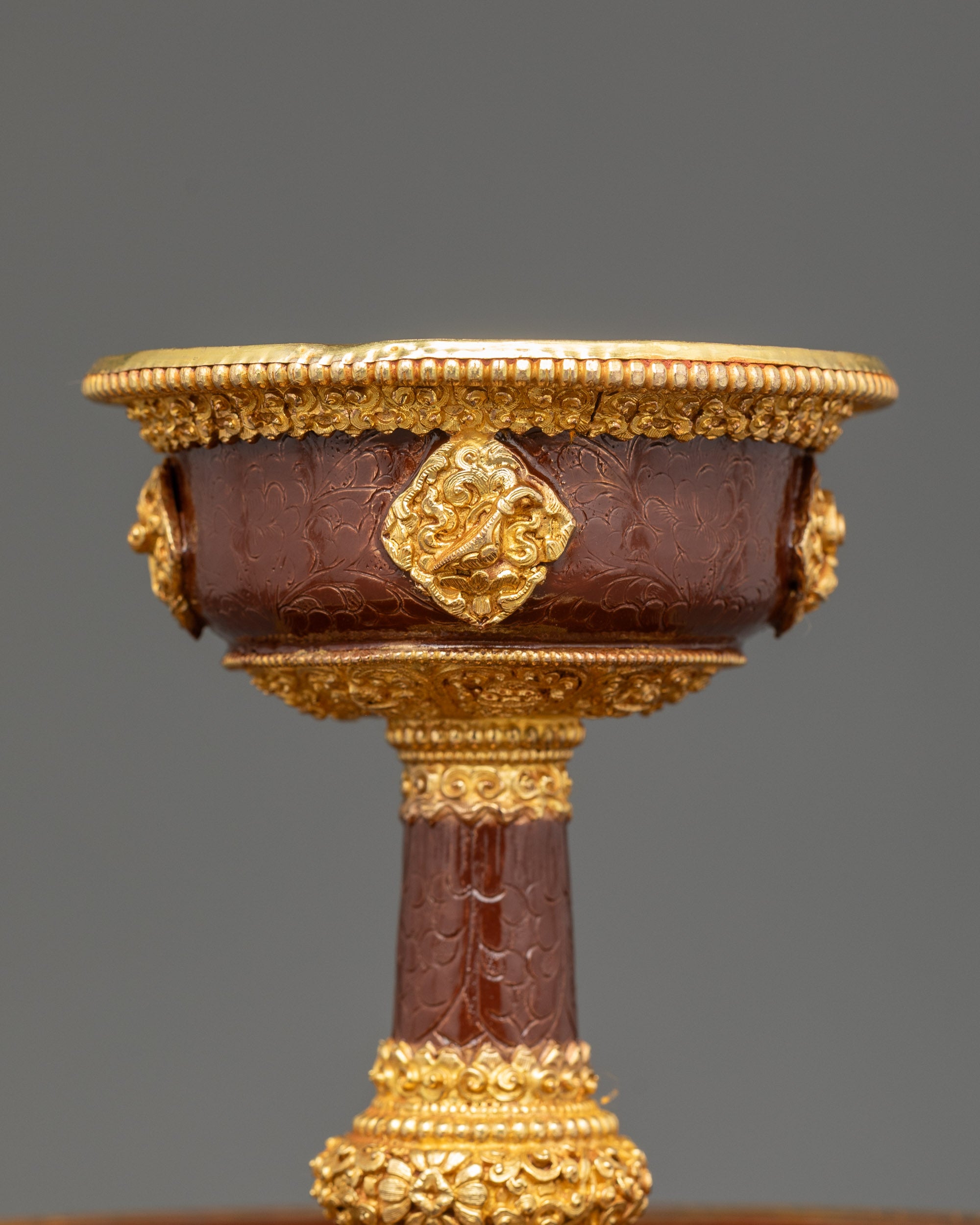 Close up Golden Serkyem Offering showing handcrafted copper and gold-plated details