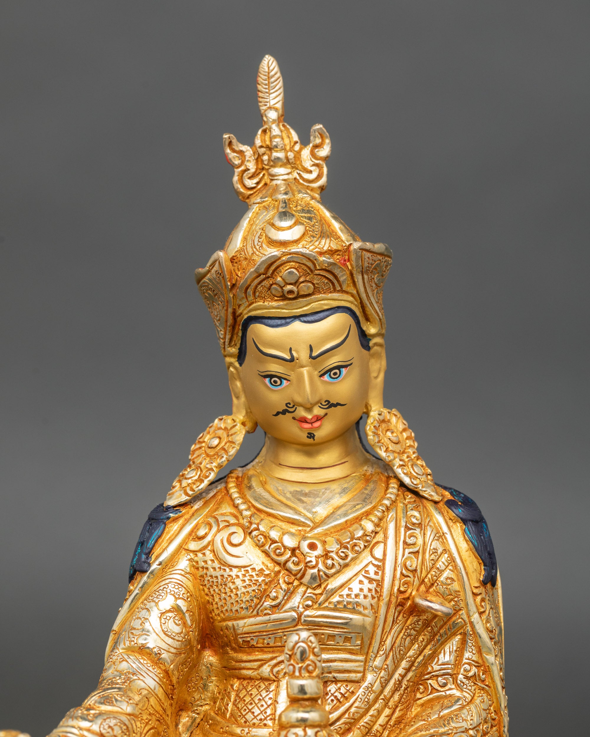 Close up Guru Rinpoche statue showing wrathful yet compassionate expression