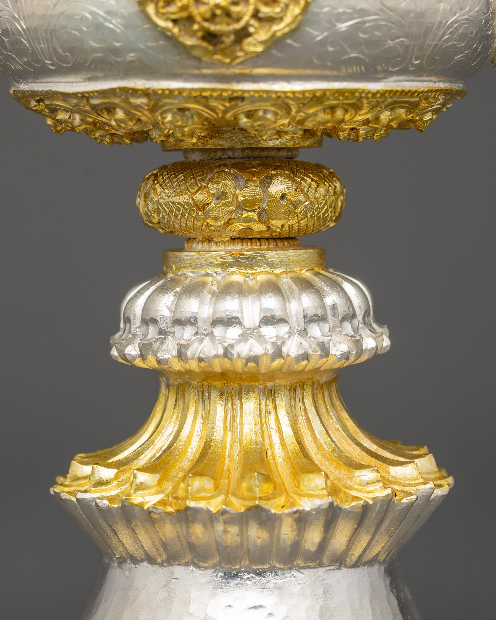 Close up Himalayan copper Butter Lamp with intricate Buddhist carvings