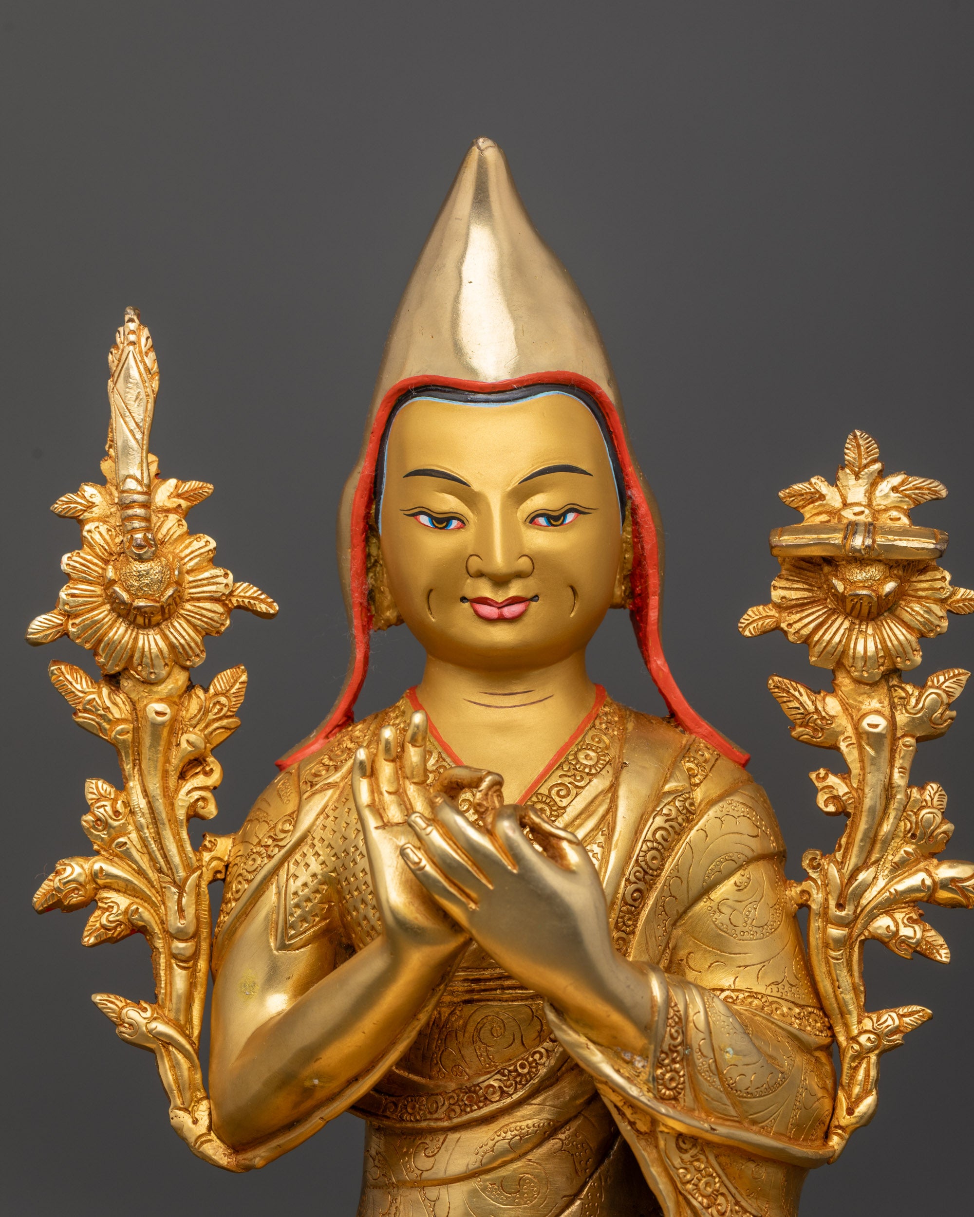 Close up Je Tsongkhapa statue with dharmachakra mudra and utpala flowers detail