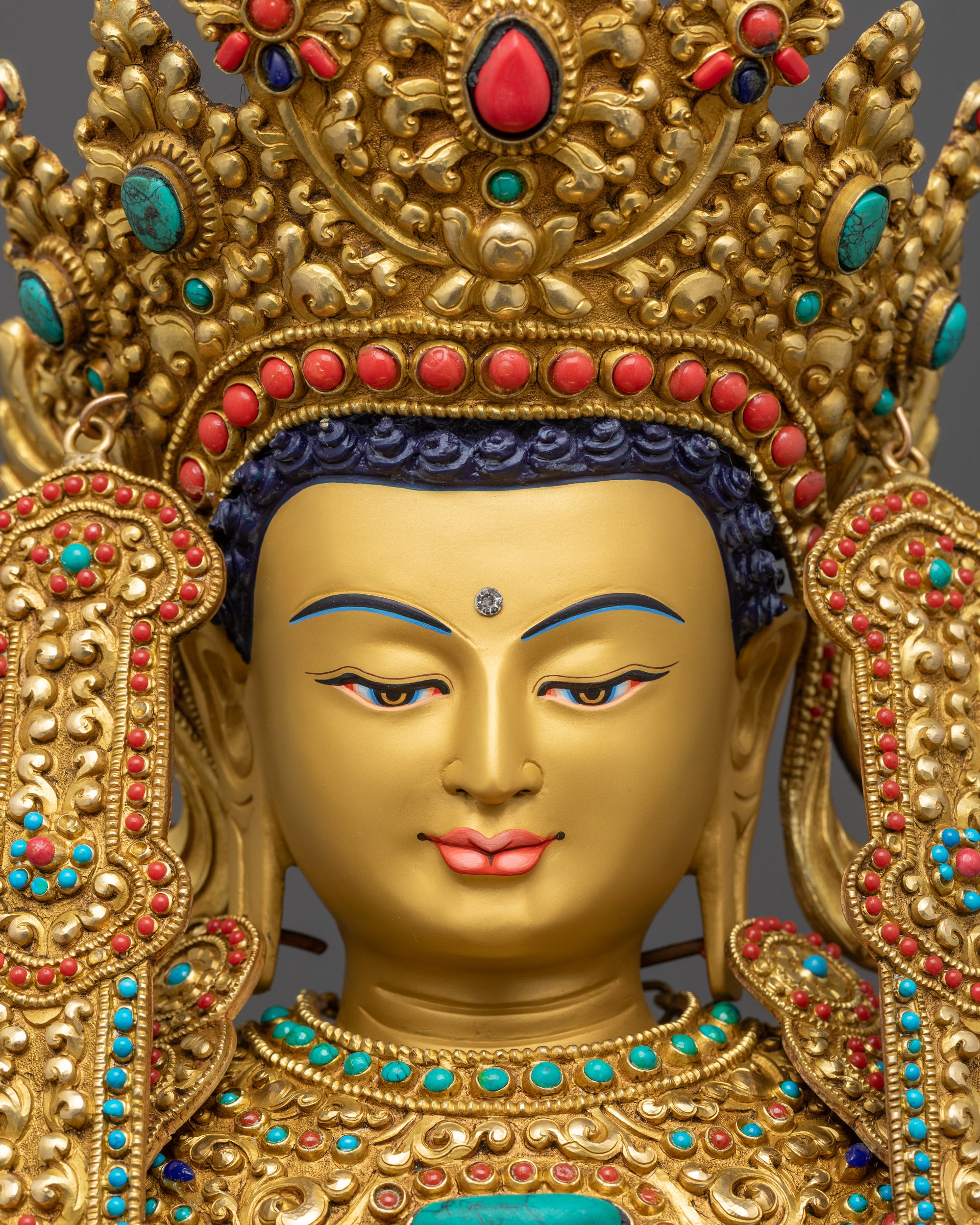 Close up Jowo Rinpoche Buddha Statue showing gold-gilded face and semi-precious stones