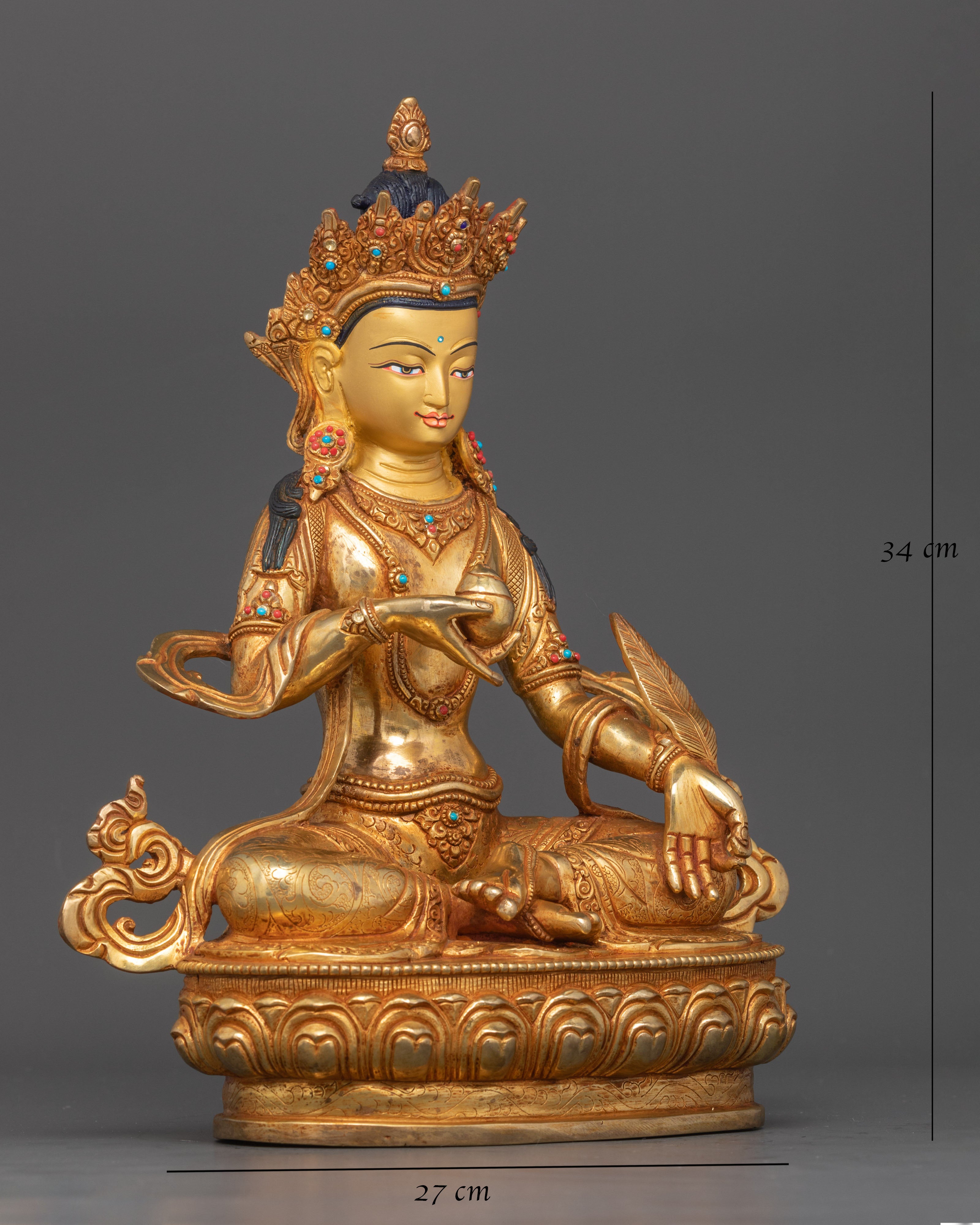 Close up Ksitigarbha gold-painted face turquoise coral inlaid details