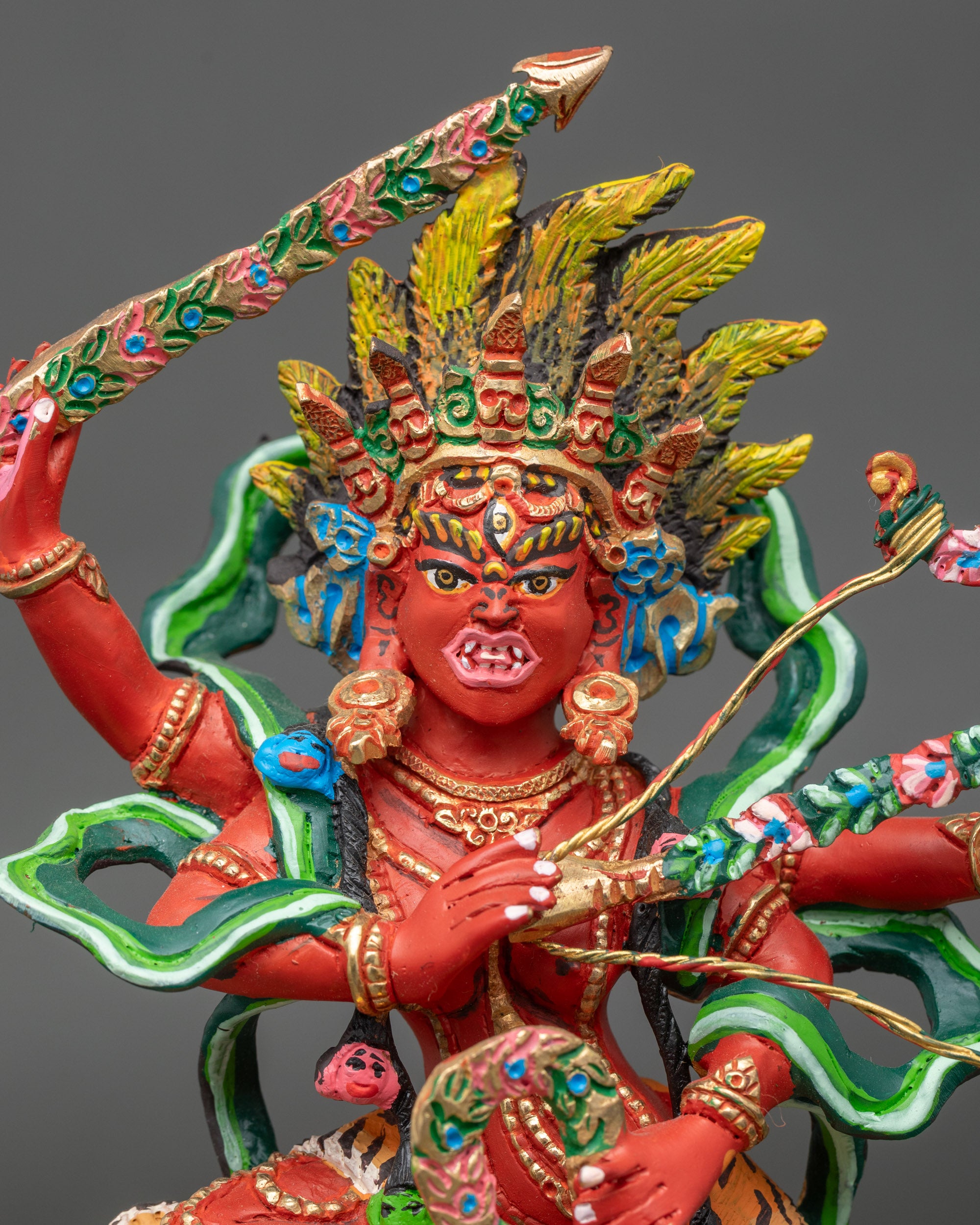 Close up Kurukulla face third eye five skull crown semi wrathful deity